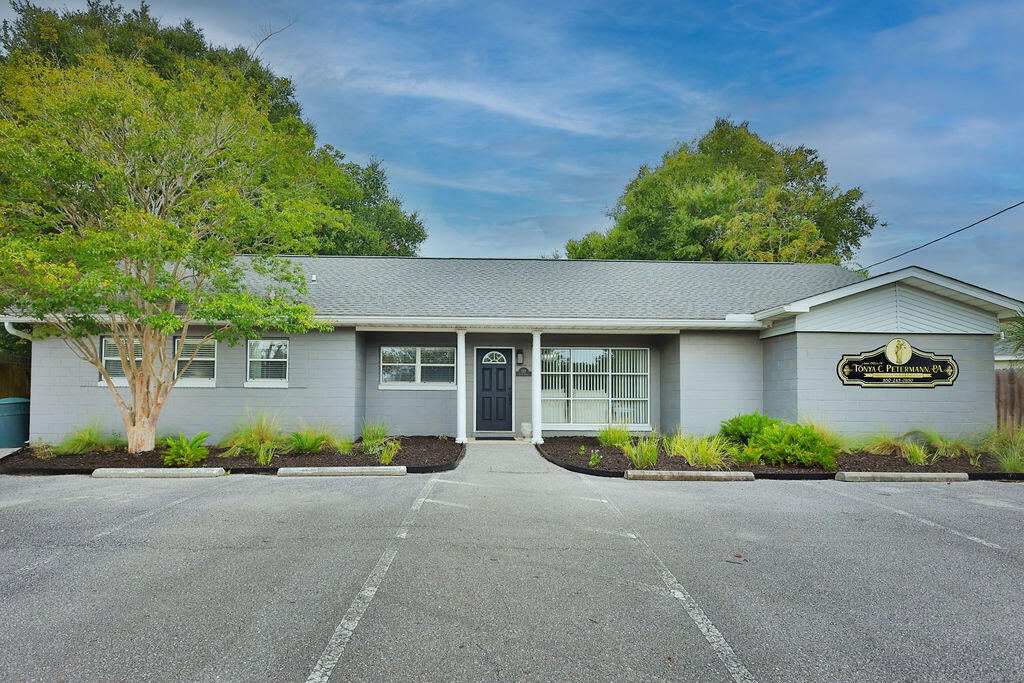 A rare opportunity to own a renovated professional property in one of Fort Walton Beach's quickly revitalizing areas--offering exceptional convenience to both downtown and the beaches while providing a work environment that feels distinctly removed from the typical commercial setting.

The property enjoys an especially desirable location backing up to one of the area's most coveted residential communities, known for its beautiful parks, yacht club, golf-cart-friendly streets, and easy connection to downtown Fort Walton Beach. Just steps from the property, Ferry Park offers a one-mile walking and fitness path, creating the opportunity for a morning walk, lunchtime exercise, or an outdoor break during the workday. Starbucks and other nearby conveniences are also within walking distance.

This combination creates something increasingly difficult to find: **a professional setting designed around both productivity and quality of life.**

The renovated interior is currently configured as a law office and features:

* Three private offices
* Large conference room
* Two bathrooms, including one full bathroom with shower
* Kitchenette
* Heated and cooled storage space
* Flexible common and work areas

Outside, an unusually large backyard adds another dimension to the property and creates opportunities rarely available with traditional office space. Depending upon the future owner's needs and applicable zoning, the outdoor area could potentially accommodate gardens, relaxation areas, outdoor meeting space, wellness programming, or other creative uses.

While ideally suited for another professional office, the property's layout, full bathroom, outdoor space, and proximity to Ferry Park also make it particularly intriguing for a wellness practice, boutique spa, therapy or counseling office, creative studio, health-focused business, or other professional concept seeking a more inviting environment for clients and employees.

Convenient to downtown Fort Walton Beach, area neighborhoods and the beaches, this is an opportunity to own more than office space--it is a chance to create a workplace where business, wellness, and quality of life come together.