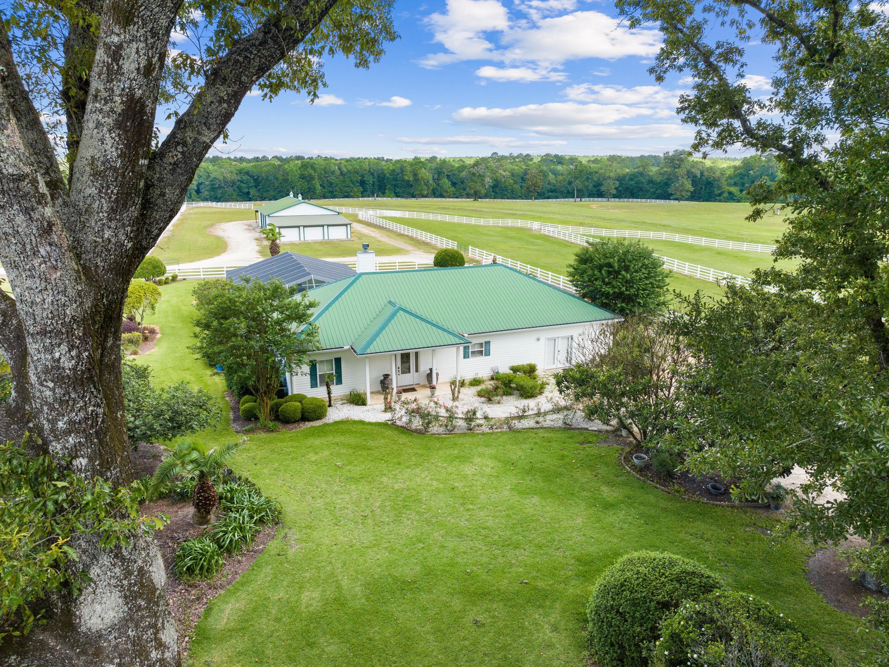 Horse lovers and equine professionals will covet this working ranch that rivals any facilities elsewhere. It boasts a world-class equestrian facility, purposely designed for training, boarding and breeding horses, or perhaps for enjoying as a private retreat for the new owner and horses. The pristine 42-acre property includes a beautiful home, three barns and several wells. It has seven fenced paddocks with prime Argentine Bahia grass and automated watering systems. Serious riders will appreciate the lighted outdoor riding arena with footing designed for performance horses. The 4,800-sq.-ft. modern horse barn can withstand winds up to 140 mph.