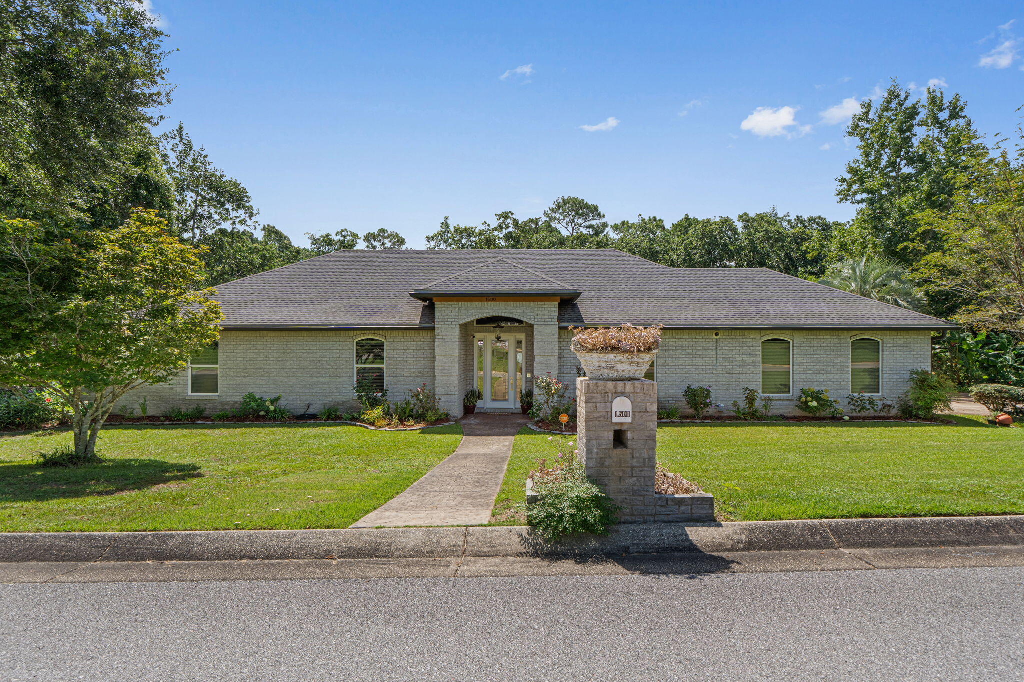 Gorgous custom pool home in the much sought after Westchester neighborhood. Rare to find a home that sits on +/- 1.25 acres. From the moment you step in the front door you see all of the fantastic upgrades. Travertine tile floor entry way, art deco glass doors, crystal chandeliers, soaring ceilings, rich engineered wood floors. Fireplace in the living room. Cherry custom cabinets and Viking appliances in the kitchen. Very generous sized primary suite with a spa like bathroom. The other two bedrooms are great sizes and share a bathroom. 1/2 bath for guests and a 3rd bathroom off the lanai. Lush wooded area behind the home allows for plenty of privacy for the pool and lanai! You can tell that a gardener lives here as the grounds of the property are so well maintained. Small shed by the driveway. This is a fantastic property to enjoy the year round!