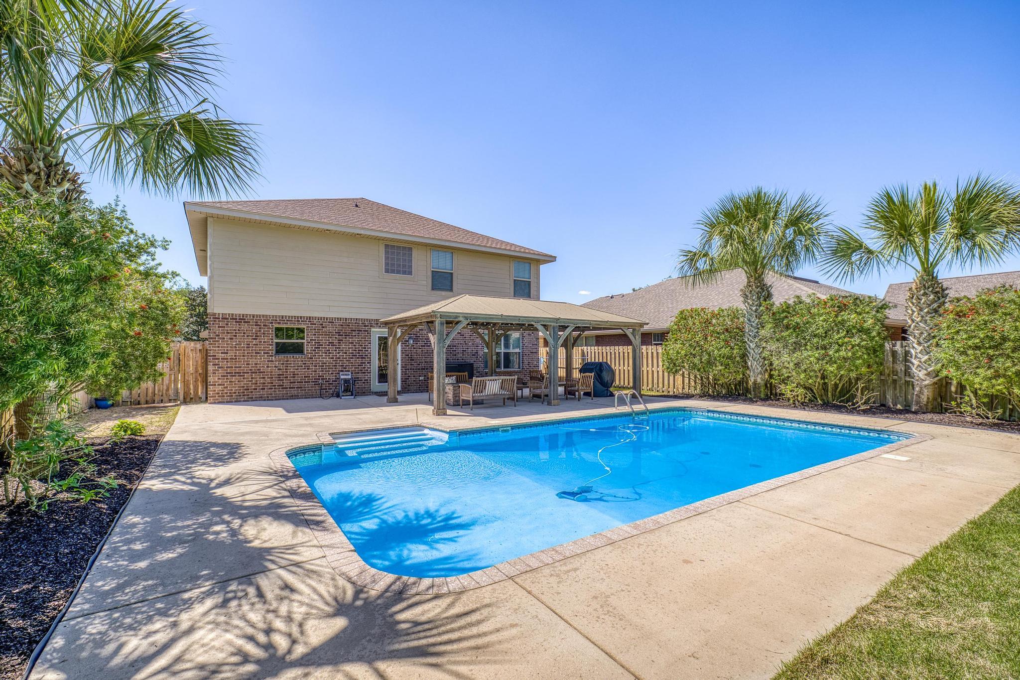 Motivated Sellers!!!Discover this stunning modern coastal contemporary two-story home in the highly sought-after Woodlawn Heights community of Gulf Breeze. Boasting five spacious bedrooms, three full baths, a generous family room, and a versatile bonus loft, this 2015-built residence offers approximately 2,288 square feet of thoughtfully designed living space.
Inside, enjoy updated features and high-end finishes throughout, including a chef-friendly kitchen with granite counters, stainless steel appliances, a breakfast bar, and an open layout perfect for entertaining. The bright, airy interiors create a welcoming atmosphere ideal for both relaxing and hosting.
Step outside to your private backyard oasis -- a true resort-style retreat featuring mature palm trees, lush tropical landscaping, and a large heated saltwater pool. Gather around the lighted scenic pavilion with its cozy fire pit for unforgettable evenings under the stars. Whether you're swimming year-round or entertaining family and friends, this outdoor space delivers everyday luxury.
Woodlawn Heights offers an exceptional lifestyle with community ponds, a playground, walking trails, and sidewalks throughout. A public boat launch is conveniently located within a half mile, making it easy to enjoy Santa Rosa Sound and the Gulf. The neighborhood is situated just 15 minutes from Navarre Beach, 20 minutes from Pensacola Beach, and less than 30 minutes from both downtown Pensacola and Hurlburt Field. Everyday conveniences are even closer -- Walmart, Publix, and Lowe's are all less than 10 minutes away.
This prime location combines coastal charm, modern comfort, and unbeatable access to beaches, bases, shopping, dining, and top-rated schools. Don't miss your chance to make this move-in-ready home yours!"