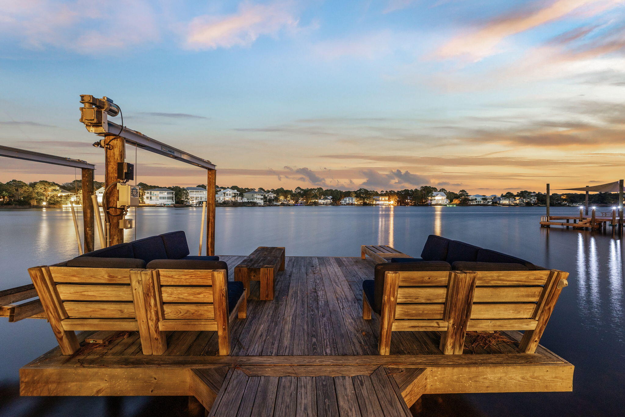 Gracefully, positioned on a high waterfront lot with 85 feet of frontage along Eastern Lake, this four-bedroom brick residence offers a captivating setting on one of 30A's treasured coastal dune lakes. Framed by mature oaks and just a short stroll to beach access, the property beautifully blends lakefront serenity with the coastal lifestyle.
Expansive windows draw the natural surroundings into the kitchen and living areas, showcasing picturesque views across the lake. Outside, custom multi-tiered decking creates an inviting extension of the home and an idyllic setting for quiet mornings, sunset gatherings and relaxed waterfront living.
At the heart of the home, the generously sized kitchen is designed for both entertaining and everyday enjoyment. Granite countertops, a tiled backsplash, a Wolf range, an Asko dishwasher and custom Kraft cabinetry bring function and timeless style to the space.
Four bedrooms provide comfortable accommodations for family and guests, while the home's gracious living spaces and exceptional setting allow it to serve beautifully as a primary residence, coastal retreat or rental property. New boat lift installed. Outdoor sauna included.