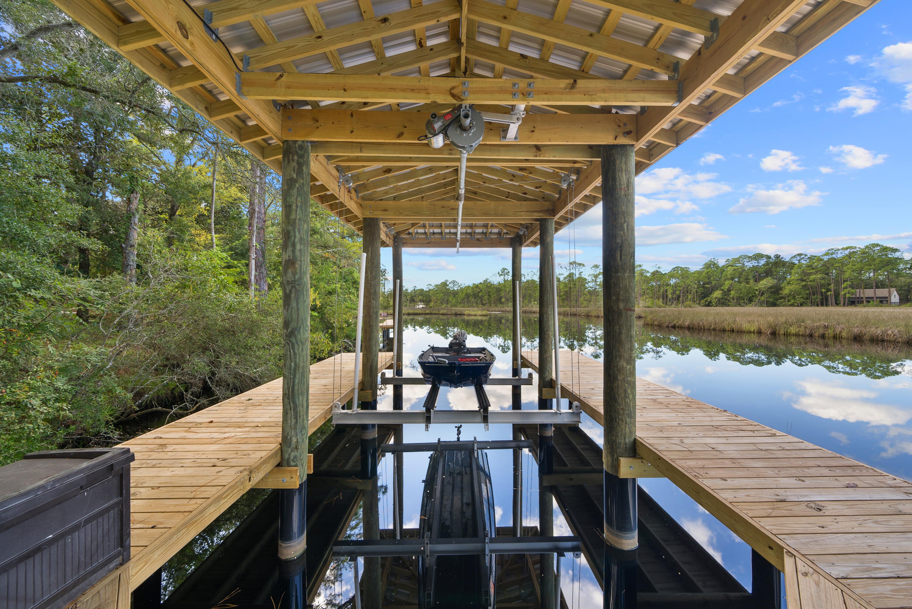 Situated on nearly three-quarters of an acre, this exceptional waterfront property offers privacy, space, and coastal charm. The home features 4 bedrooms, 3.5 bathrooms, and a 3-car garage, with a flexible layout designed for comfortable living and entertaining. A private bedroom, bathroom, and living area provide the perfect setup for a mother-in-law suite, guest quarters, or home office. Two additional guest bedrooms share a spacious bath with double vanities, while the open living areas create a warm and inviting atmosphere. The kitchen overlooks the main living space and includes quartz countertops, a farmhouse sink, stainless steel appliances, and a large island with bar seating. Adjacent dining and breakfast areas offer plenty of room for everyday meals and gatherings. Enjoy direct access to Choctawhatchee Bay from your private covered boat slip with boat lift! This makes boating, fishing, paddleboarding, and sunset cruises easily accessible directly from your backyard. Surrounded by mature landscaping in a peaceful South Walton County setting, this property presents a rare opportunity to enjoy waterfront living with room to grow. Whether you're looking for a primary residence, second home, or investment property, this home is ready for your personal touch. Conveniently located just minutes from the Emerald Coast's renowned beaches, dining, shopping, and entertainment, this is waterfront living at its best.