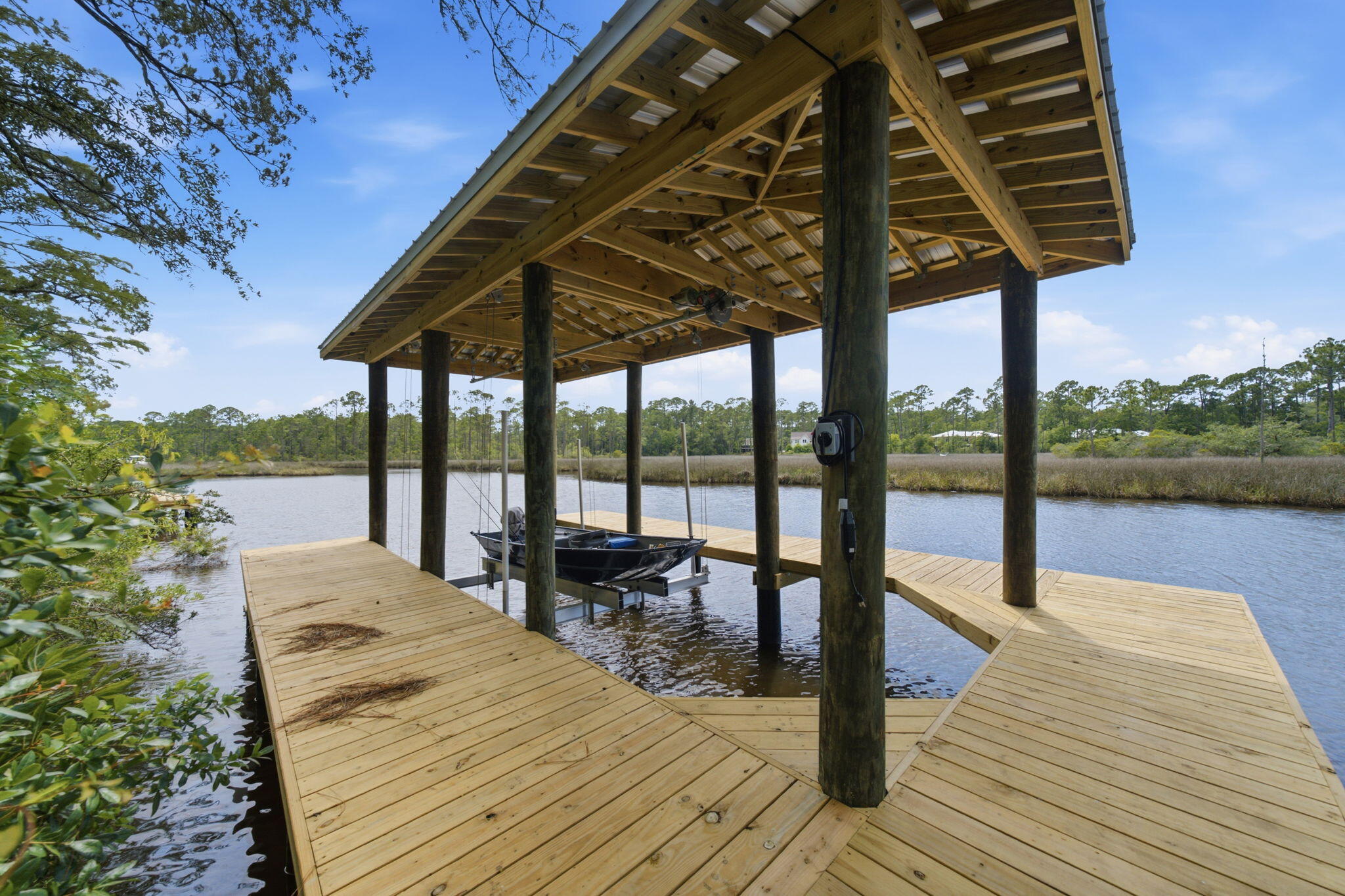 Situated on nearly three-quarters of an acre, this exceptional waterfront property offers privacy, space, and coastal charm. The home features 4 bedrooms, 3.5 bathrooms, and a 3-car garage, with a flexible layout designed for comfortable living and entertaining.

A private bedroom, bathroom, and living area provide the perfect setup for a mother-in-law suite, guest quarters, or home office. Two additional guest bedrooms share a spacious bath with double vanities, while the open living areas create a warm and inviting atmosphere.

The kitchen overlooks the main living space and includes granite countertops, a farmhouse sink, stainless steel appliances, and a large island with bar seating. Adjacent dining and breakfast areas offer plenty of room for everyday meals and gatherings.

Enjoy direct access to Choctawhatchee Bay from your private dock and boat lift, making boating, fishing, paddleboarding, and sunset cruises easily accessible from your backyard.

Surrounded by mature landscaping in a peaceful South Walton County setting, this property presents a rare opportunity to enjoy waterfront living with room to grow. Whether you're looking for a primary residence, second home, or investment property, this home is ready for your personal touch.

Conveniently located just minutes from the Emerald Coast's renowned beaches, dining, shopping, and entertainment, this is waterfront living at its best.
