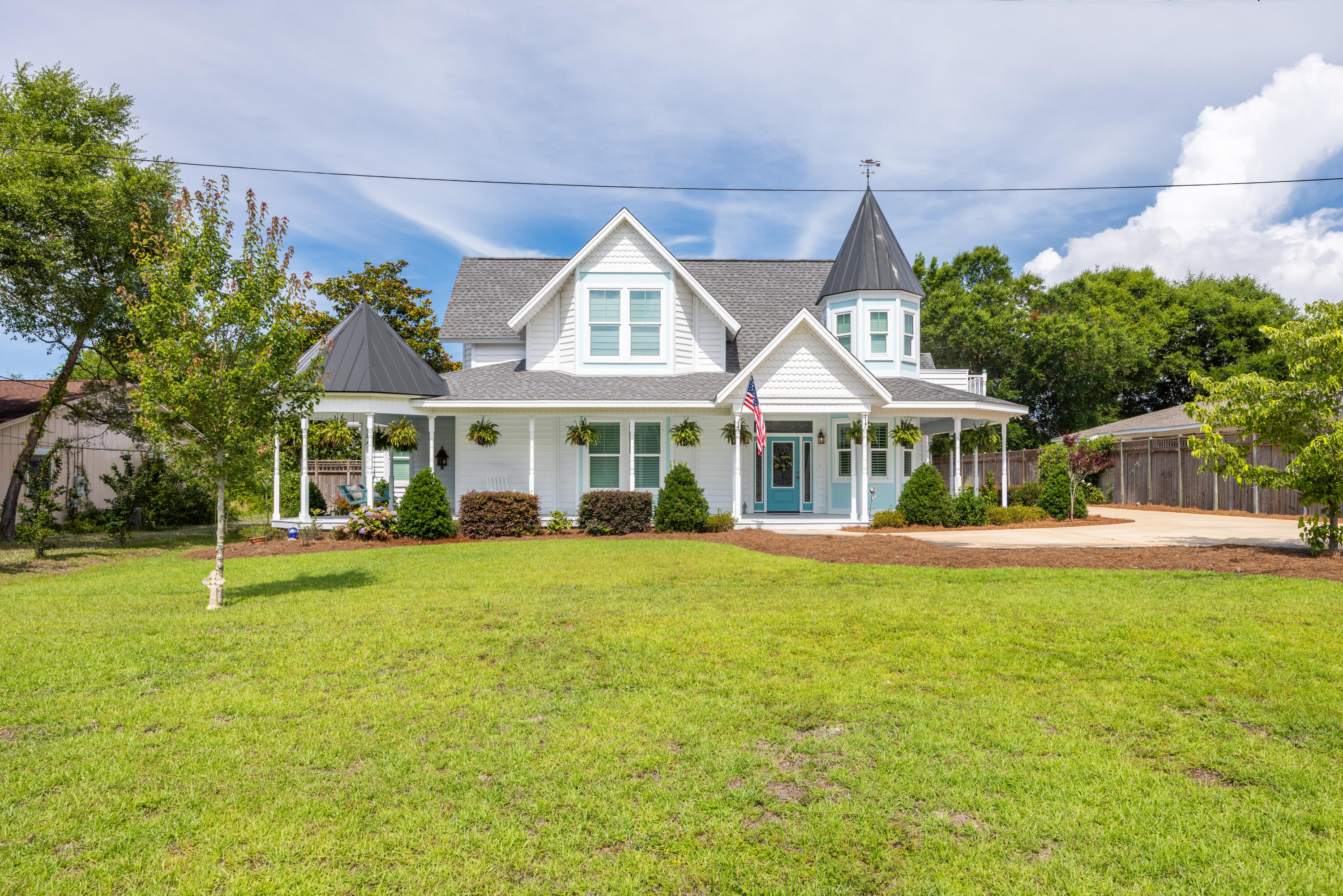 Experience the charm and character of this exceptional Victorian-inspired residence, masterfully built by acclaimed local builder David Meyer. Showcasing timeless architecture, a distinctive turret, and an inviting wrap-around porch, this home blends classic elegance with modern comfort in a highly desirable location near the Emerald Coast's renowned beaches, shopping, and dining.  Inside, the thoughtfully designed floor plan offers seamless flow between the living, dining, and kitchen areas, creating the perfect setting for entertaining and everyday living. A cozy fireplace anchors the main living space, while the chef's kitchen impresses with quartz countertops, stainless steel appliances, a gas cooktop, custom cabinetry, and stylish designer finishes.  The formal dining room is truly unforgettable, highlighted by a stunning domed ceiling featuring hand-painted cloud details that add a touch of artistry and sophistication. The spacious first-floor primary suite serves as a private retreat, complete with a sitting area, spa-inspired bath, dual vanities, an oversized walk-in closet, and a relaxing soaking tub.  Upstairs, you'll find three additional bedrooms along with the home's signature turret room--a magical space ideal as a reading nook, home office, or creative retreat.  One of only five beautifully crafted Victorian-style homes on the street by the same respected builder, this property offers a rare opportunity to own a truly distinctive residence. Enjoy convenient access to world-class fishing, sugar-white beaches, premier shopping, excellent dining, and all that the Emerald Coast lifestyle has to offer.