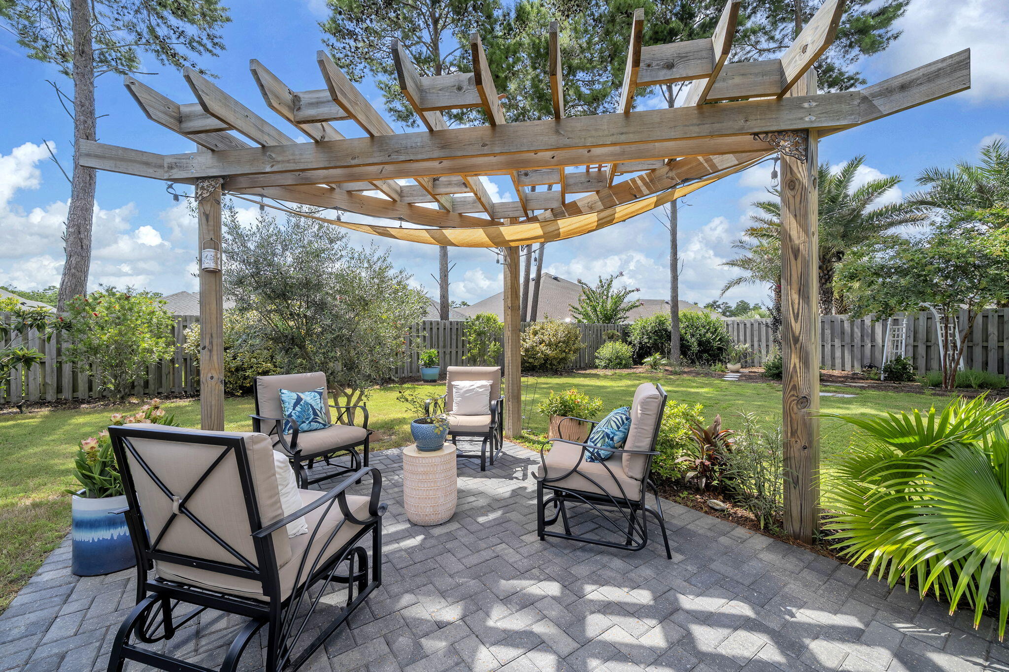 This is not your typical Hammock Bay home in Freeport, Florida. With more than $27,000 invested in improvements over the past two years and an incredible private backyard designed for Florida living, 283 Sweet Tea Lane offers something different from many of the homes currently on the market.
The owners planned to make this their long-term home and invested accordingly. Recent improvements include upgraded LVP flooring, fresh interior paint, a beautifully updated laundry room with upper and lower cabinetry and a deep utility sink, a whole-home air scrubber, added return ducts and filtration improvements, Wi-Fi thermostat, Wi-Fi-controlled irrigation, and upgraded lighting and kitchen hardware. The property also includes a powered and insulated workshop/shed, adding valuable space for projects, hobbies, or storage. Inside, the bright, open floor plan is warm and inviting. The kitchen is designed for gathering with quartz countertops, a gas range, oversized island, walk-in pantry, and butler's pantry. A dedicated office with glass doors provides a separate work-from-home space, while the private guest suite with its own full bath is ideal for visitors. But the backyard may be what sets this home apart most. With no home directly behind you, the outdoor living space feels wonderfully private. An expansive screened porch leads to the hot tub and extended screened area, while brick pavers connect the pergola, fire pit, greenhouse, raised garden beds, and beautifully landscaped yard. Oranges, limes, loquats, blackberries, grapes, olives, and fresh herbs are already growing here. It's a backyard designed to be lived in, not just looked at.
The location offers another advantage. Situated near Hammock Bay's west entrance and traffic light, you'll have convenient access to Highway 20 without traveling through the entire community.
Hammock Bay amenities include resort-style pools, pickleball and tennis courts, a fitness center, dog parks, Props Brewery, miles of walking and biking trails, and year-round community events at The Green.
Updated, private, thoughtfully improved, and offering an outdoor living space that's difficult to duplicate. Some homes simply need to be experienced in person. Come see what makes 283 Sweet Tea Lane different.