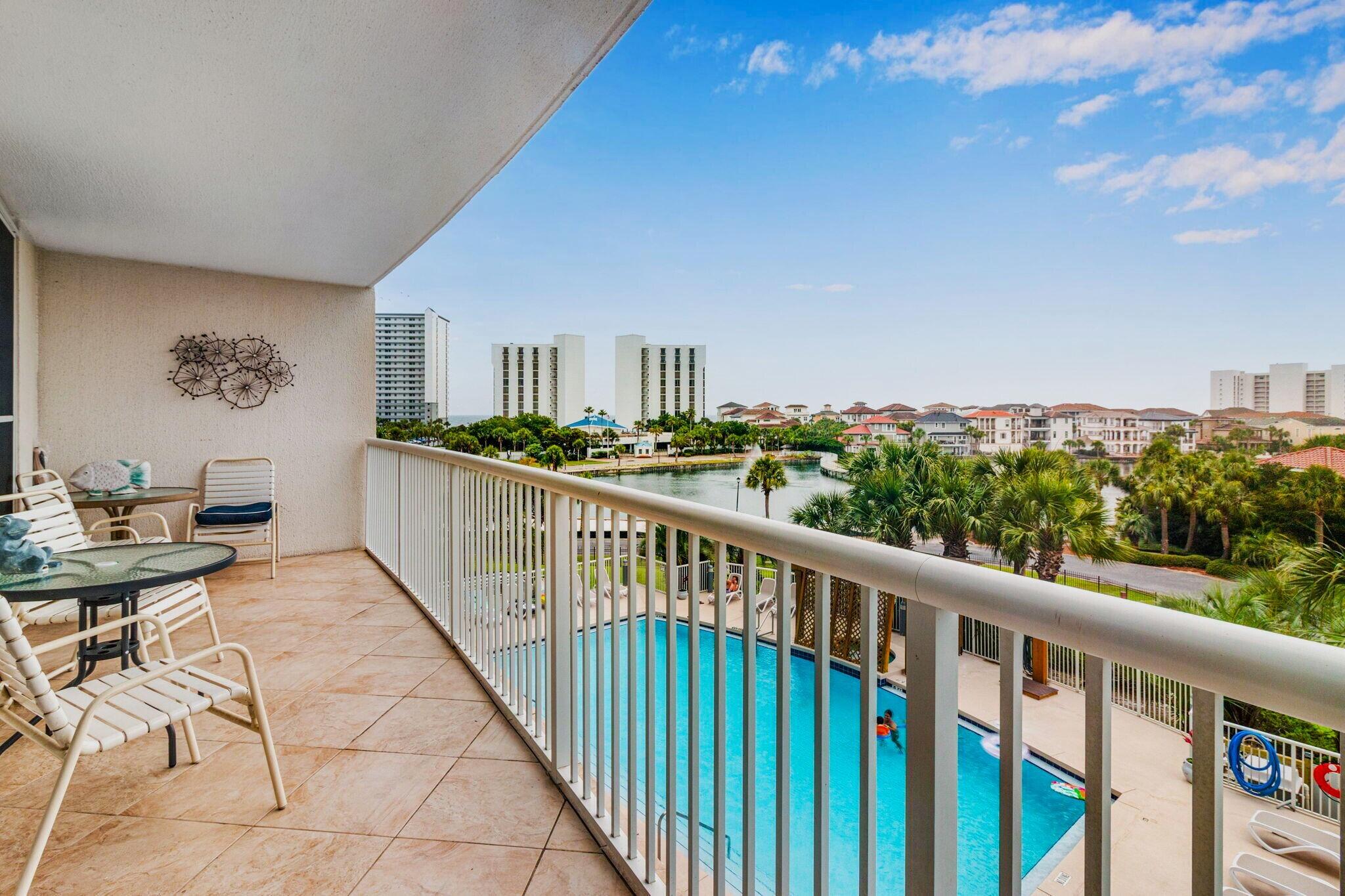 Owning in one of Destin's most popular beachfront resorts usually comes with a much higher price tag. Located within The Terrace at Pelican Beach Resort, this fully furnished 2-bedroom, 2-bath condominium offers private deeded beach access, short-term rental eligibility, resort-style amenities, and views toward Destin Harbor, the Gulf of Mexico, and beautiful Emerald Coast sunsets.

Owners and guests enjoy access to one of Destin's most amenity-rich resort communities, featuring multiple pools, hot tubs, fitness facilities, tennis courts, pickleball courts, a game room, on-site dining, gated security, and more. Whether you're spending the day on the beach, relaxing poolside, or exploring nearby shopping, dining, boating, and entertainment, everything that makes Destin one of Florida's premier vacation destinations is just moments away.

One of the property's most compelling advantages is its flexibility. Enjoy the condo as a personal beach retreat, second home, or vacation getaway while allowing rental income to help offset the cost of ownership when you're not using it. Professional rental projections indicate the potential for approximately $45,000+ in annual gross rental revenue, making this an attractive option for buyers seeking a vacation home with income-producing potential. Meticulously maintained and offered fully furnished, this 2-bedroom, 2-bath residence features soaring ceilings and an open layout that lives larger than its square footage suggests. The unit's position within the building provides views overlooking the pool while also capturing spectacular western sunsets from the private balcony. Beyond the resort grounds, views stretch toward Destin Harbor and the Destin Bridge, creating a unique backdrop of passing boats, harbor activity, and evening skies.

The Terrace offers one of the most attractive entry points into the Pelican Beach Resort lifestyle. Combining private beach access, resort amenities, rental flexibility, water views, and a central Destin location, this property delivers a compelling opportunity for buyers looking to create family memories at the beach while potentially allowing vacation renters to help subsidize a meaningful portion of ownership costs.