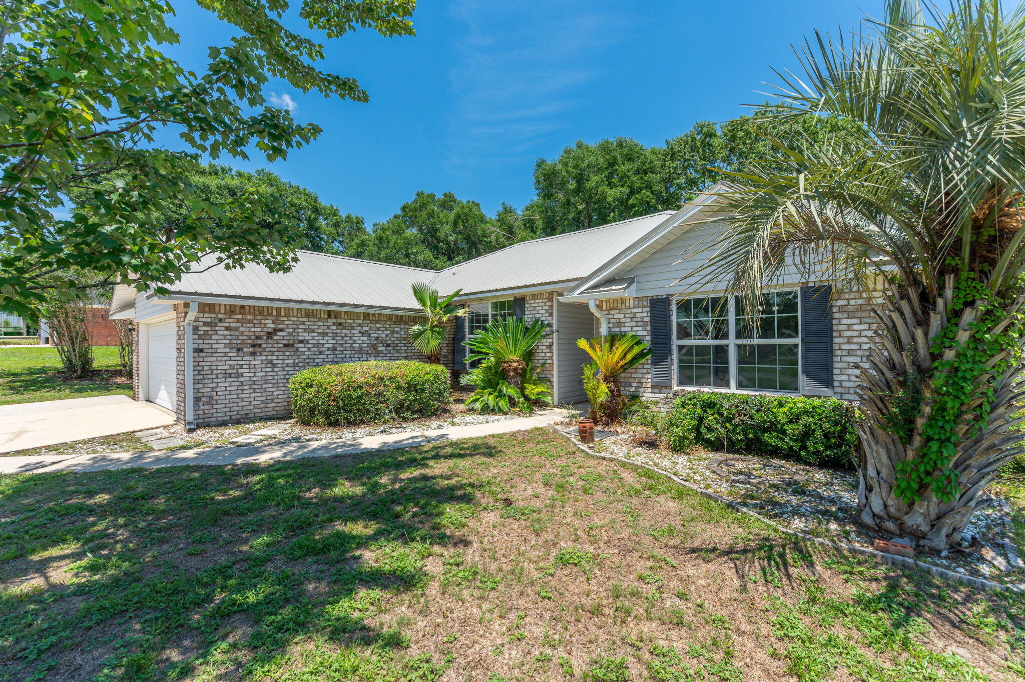 Welcome to this charming 3-bedroom, 2-bath home with a metal roof installed in 2023 located in desirable South Crestview! Offering a functional layout and thoughtful features throughout, this home is ready for its next owner.

The spacious kitchen is designed with both style and convenience in mind, featuring beautiful granite countertops, ample cabinet space, and plenty of storage for all your cooking and organizational needs. The living room and dining area provide a comfortable setting for everyday living and entertaining.

The primary suite offers well-appointed en-suite bathroom that includes a double vanity and two separate closets, providing plenty of room for storage and organization. Two additional bedrooms and a full guest bathroom offer flexibility for family, guests, or a home office.

Step outside to enjoy the screened porch, fenced backyard, perfect for pets, play, or relaxing evenings outdoors. A standout feature of this property is the detached exterior building with electricity already connected, making it an ideal man cave, she shed, workshop, hobby space, home gym, or office.

Conveniently located in South Crestview with easy access to local shopping, dining, schools, and military bases. This home combines comfort, functionality, and versatility. Don't miss your opportunity to make this wonderful property your own. Schedule your showing today!