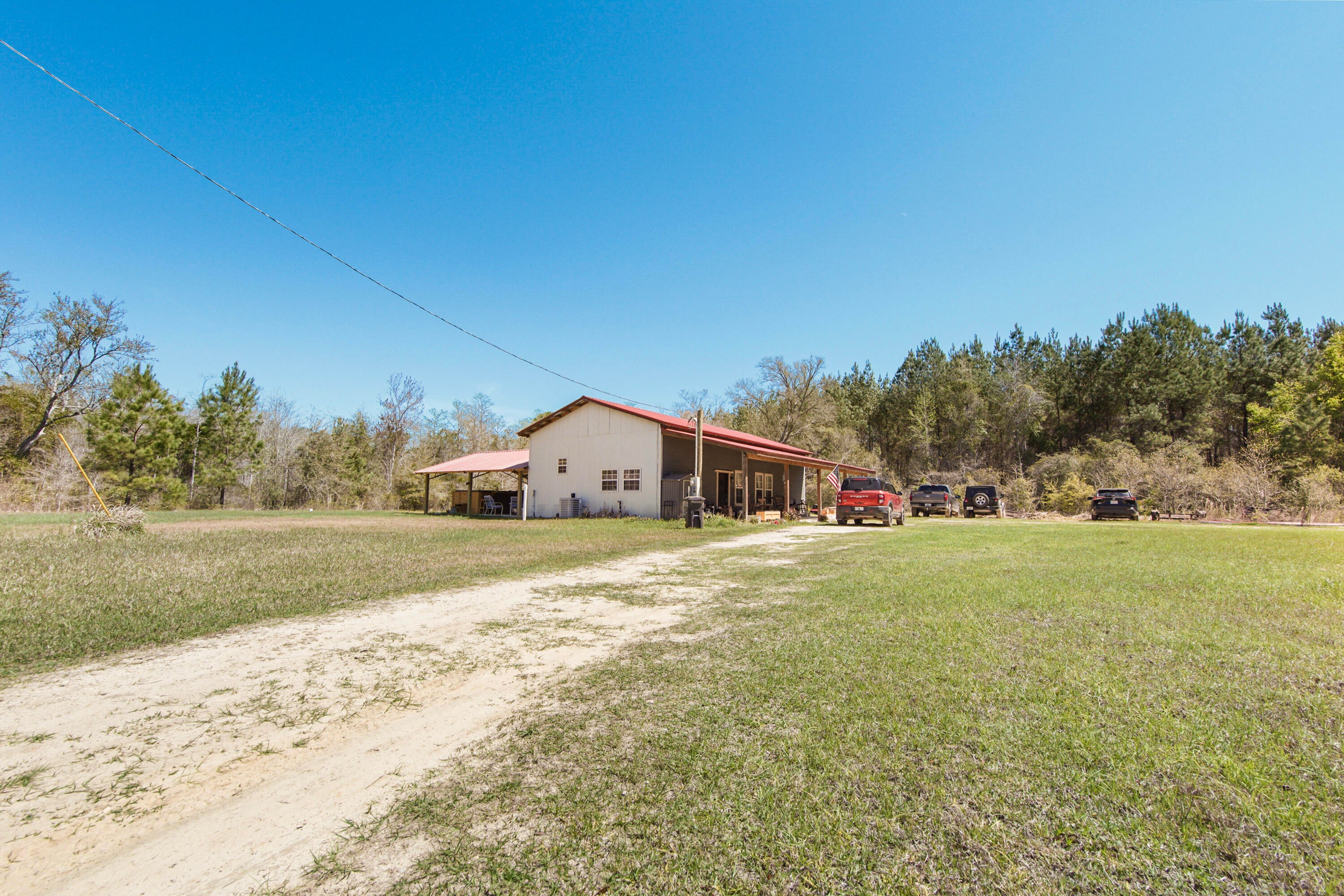 The Modern Homestead: With More Character than a John Wayne Marathon! 
We're burning daylight over here! Tucked away just outside of Bonifay, this 21.51-acre estate is the ultimate ''getaway'' that you never have to leave.  If you've been looking for the ultimate escape where modern integrity meets old-world soul, this is your destination. 
The Barndominium: Where Grit Meets Glamour.
Forget what you know about ''rustic.'' Built in 2022, this custom barndominium blends the structural integrity of a modern build with the soul of a vintage farmhouse.
Adorned with a vintage, artisan interiors -  Stepping inside is like walking into a magazine. Adorable, warm, and rich with reclaimed materials that tell a story.
A massive, open-concept living space welcomes you home - designed for entertaining or unwinding after a day in the woods.  The master suite features a walk-in closet so large it's practically its own zip code. (This space could be a ''blank canvas'' and easily converted into a bunk room or home office).
Both the kitchen and bath are perfectly appointed with ''rustic-chic'' finishes that prove you don't have to sacrifice style for the country life.
21 Acres of Opportunity! 
Comes with it's own privacy screen! The front of the over 21 acres features a lush, natural wetland buffer providing an organic area that shields the homestead from the road. Once you pass through, you enter a high and dry paradise shaded by massive, mature trees. It's quiet, it's secluded, and it's yours. Relax on more than one level! Unwind in your private swim spa--the perfect way to cool off after a morning of land management or hunting. The ultimate year-round luxury for fitness and relaxation. Worth mentioning - Includes a pole barn and multiple sheds. Whether you have tractors, ATVs, or a woodshop hobby, there's a place for it. This is the ultimate ''set-and-forget'' property. Use it as your primary residence and breathe the fresh air or keep it as the world's most sophisticated hunting lodge. With 21+ acres, there is limitless room to expand. The sellers are ready to pass the torch! Properties with this much acreage and a 2022 build do not last in this price bracket. ''I'm looking for a place where a man can breathe'' John Wayne. Giddy up, John. This is that.
