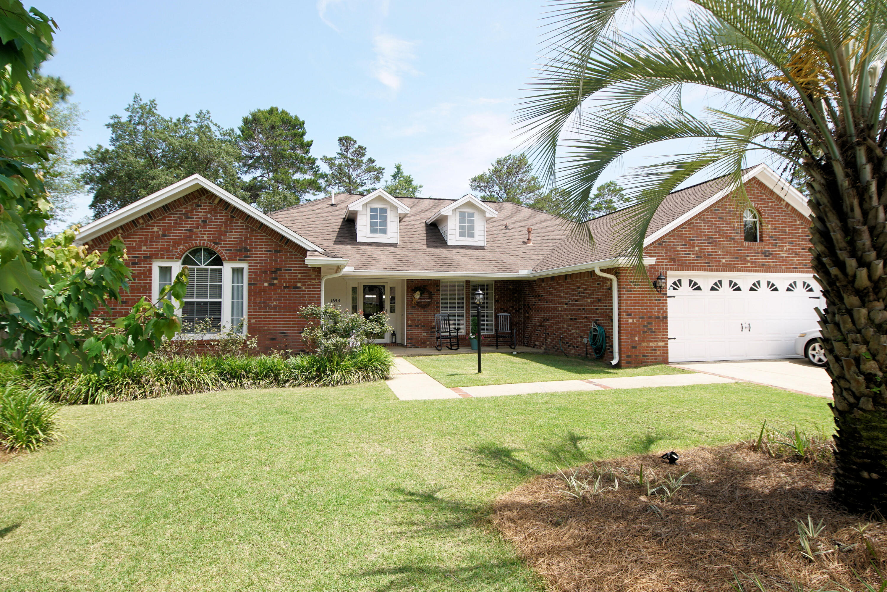 Welcome to the gated community of Parkwood Estates! We are pleased to present this beautifully maintained brick ranch home, featuring a spacious floor plan, abundant natural lighting, and a large fenced yard.
This residence offers four bedrooms and two bathrooms in a split floor plan, for added privacy for the owner's suite. The interior boasts a large eat-in kitchen with ample white cabinetry, granite countertops, and a breakfast bar. The living area is highlighted by wood flooring, a cathedral ceiling, and a fireplace, complemented by an elegant formal dining room.
Outside, the .42-acre fenced lot includes a 12x47 patio perfect for entertaining, and the oversized garage provides ample storage space. The property is located near top-rated schools, with a private gate providing direct walking access to the 'A+' Bluewater Elementary. It is also zoned for Ruckel Middle School and Niceville High School.
Recent upgrades include:
- New roof (2026)
- New HVAC system (2025)
- New privacy fence (2023)
Whether you are looking for a peaceful retreat or a home close to everything Niceville has to offer, this property delivers both style and location.
