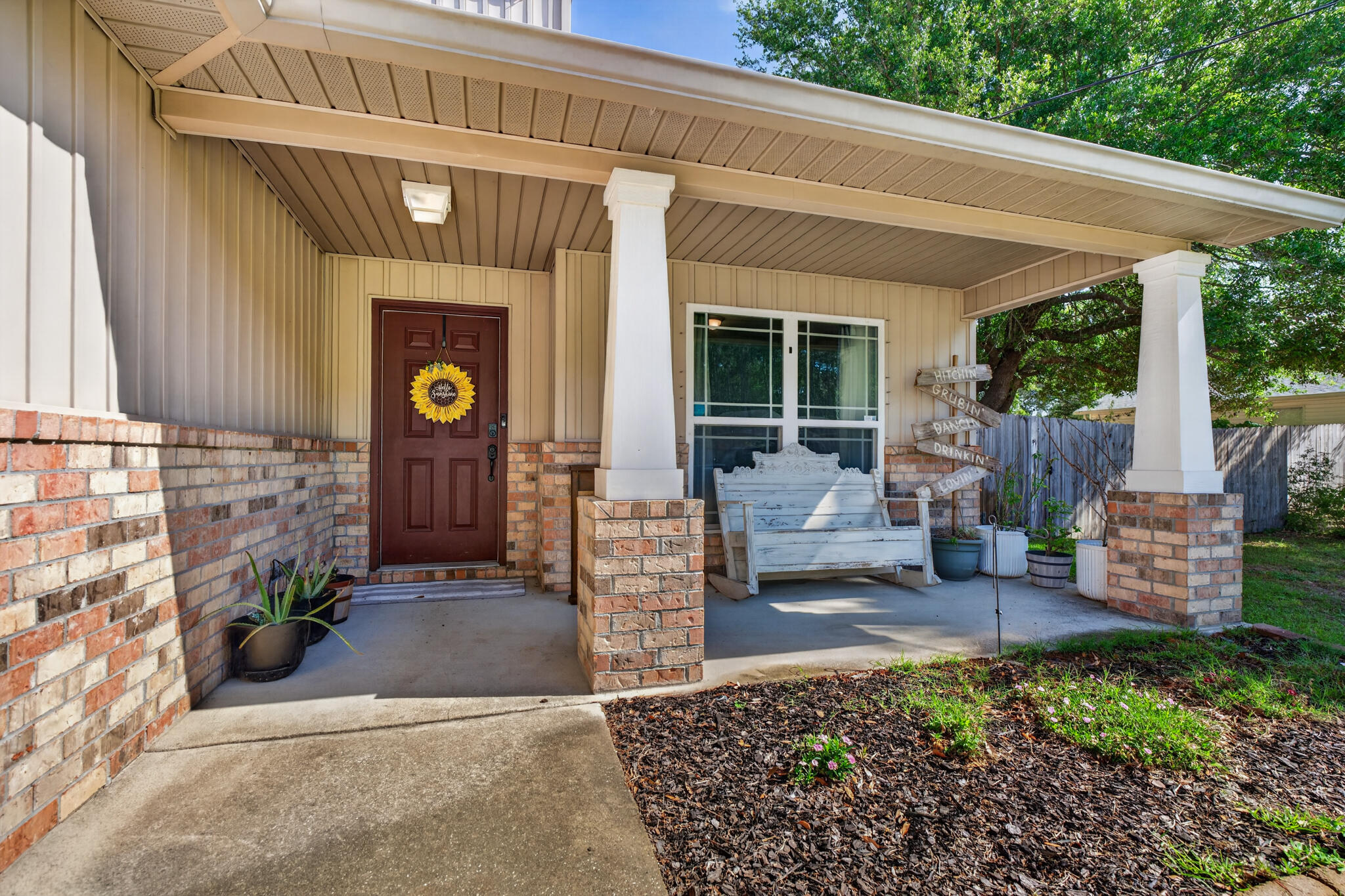 Welcome to your cozy Craftsman home--light, bright, and move-in ready. This 2014 two-story features an oversized split floor plan perfect for entertaining. Offering 4 bedrooms, 2.5 baths, plus a dedicated office off the foyer for work or study. The downstairs primary suite includes an ensuite bath with dual vanities, garden tub, and his-and-hers closets. Upstairs are three additional bedrooms and a full bath for privacy and comfort. The kitchen and dining area shine with granite countertops throughout. Large tile flooring runs through the main living areas, with tile in wet areas and carpet in bedrooms. Enjoy a .46-acre lot with room for a pool or outdoor living. A metal covered carport offers boat or RV storage. Close to top-rated schools, military bases, and beautiful beaches. video/audio surveillance on property.