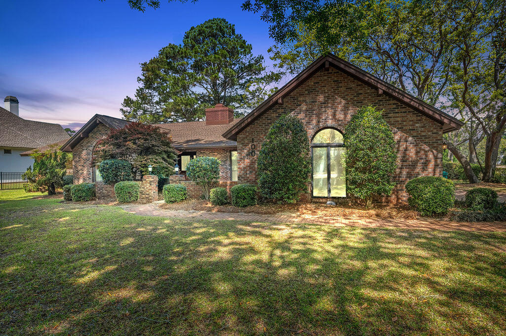 Welcome to 100 SUNSET COVE! A custom-built all-brick waterfront residence with one original owner, ideally positioned in the coveted Bluewater Bay area of Niceville. Situated on a premium half-acre corner lot with 140 feet of lake frontage, this 2795 square foot home captures sweeping lake views plus bay views in one of the area's most desirable settings. Offering 3 bedrooms, 2.5 baths, and multiple flex spaces, the layout could easily become a 4 bedroom home if desired. Recent updates include a new roof (2022), full house replumb (2022), HVAC (2017), and water heater (2013) for added peace of mind. Additional highlights include no HOA, an oversized 620 SF two-car garage with a brick paver driveway that can accommodate an RV, boat, or a commercial vehicle. Rarely does a property combine such lot size, water frontage, views, flexibility, and features so seamlessly.
Inside, the home is filled with natural light and thoughtfully designed for both comfortable living and effortless entertaining. Multiple gathering areas, a cozy fireplace and entertaining area, and flexible spaces create a warm, inviting atmosphere throughout. Two additional living areas--the living room/flex space and formal dining room--could easily be converted into 4th and 5th bedrooms, home offices, or guest spaces as needed, offering outstanding versatility for changing lifestyles.
The private primary suite is enhanced by a bonus Four Seasons Sun Room that is heated and cooled, offering panoramic views of the lake and bay. This serene retreat is perfect for morning coffee, reading, relaxing, or creating an inspiring home office with a view.
Another notable feature is the expansive back porch spanning the full length of the home--an ideal place to enjoy morning coffee, sunset skies, and serene water views year-round. Whether entertaining guests or relaxing in private, the indoor-outdoor lifestyle here is unmatched.
Additional highlights include an oversized two-car garage featuring a bonus workbench and utility sink area, with flexible extra space that could also be utilized for golf cart parking, a home gym, or a dedicated workout area.
Living in Bluewater Bay means embracing an active Florida lifestyle with access to golf courses, tennis, pickleball, swimming pools, walking and biking paths, parks, marinas, and waterfront recreation--all just minutes from your door. Residents also enjoy access to the A+ rated schools of Niceville.
Ideally situated for military and defense professionals, the home is also convenient to Eglin Air Force Base, Hurlburt Field, Duke Field, Naval School Explosive Ordnance Disposal, and 7th Special Forces Group (Airborne), with shopping, dining, and the white-sand beaches of the Emerald Coast also within easy reach.
100 Sunset Cove offers the perfect blend of privacy, space, scenic beauty, and lifestyle amenities. Experience waterfront living where every day feels like a getaway.