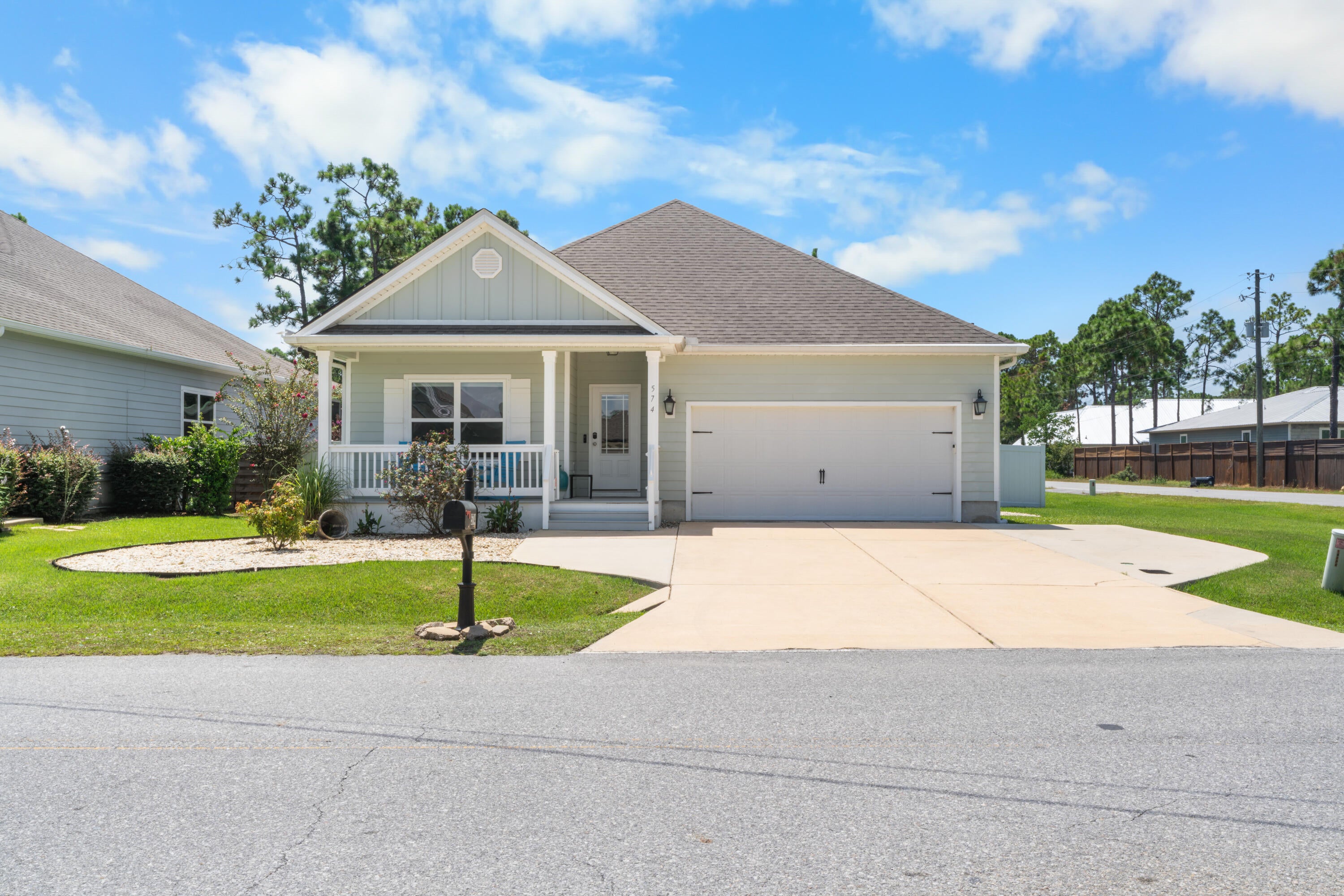 This beautifully updated corner-lot home combines luxurious finishes, modern energy efficiency, and exceptional outdoor living space with enhanced privacy and premier coastal community amenities. Neighborhood perks include HOA-owned, gated deeded bay access featuring a two-story pier ideal for gatherings and cookouts, a dedicated kayak launch, and parking space on site. A stunning screened-in, heated saltwater concrete pool anchors the pave-lined backyard, complimented by a solar system that powers the entire house and heats the pool. The property offers superior seclusion with a white fenced yard, dedicated garden space, a lawn sprinkler system running on its own dedicated well, and a deep wooded buffer separating the home from neighboring properties. Outdoor relaxation is effortless with a cozy Florida-room-style screened patio, a covered front lanai, and an expanded driveway with extra parking. Inside, beautiful wood flooring flows seamlessly throughout an open-concept layout featuring elegant tray ceilings in both the living room and primary suite. A gravity-based whole-house salt filtration water system services the home, alongside separate reverse osmosis units dedicated to the kitchen sink and refrigerator water line. The completely remodeled chef's kitchen boasts high-end GE Profile stainless steel appliances that convey, custom quartz countertops, soft-close cabinetry, and a fully built-out pantry with custom drawers. Custom painted closet built-ins maximize storage across all bedrooms, while the master suite impresses with a completely renovated bathroom showcasing designer tile, a new tub, and a custom walk-in closet system.