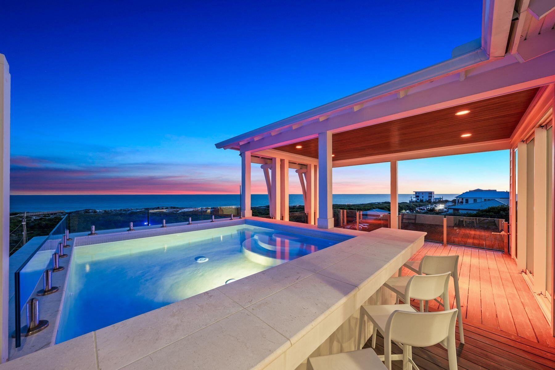 This exceptional four-level custom home in the Mala Beach community offers FOREVER Gulf views and a standard of construction rarely seen along the Emerald Coast.
Spanning 5,204 square feet, the home features an elevator servicing all levels. It includes four spacious king primary suites and two bunk bedrooms. The entryway leads the experience with a soaring Venetian plaster foyer and raised ceilings that lead into a large open living area with Peacock paver floors and floor-to-ceiling Jeldwen windows. A king bedroom features dual vanities and curated marble countertops. A marble wet bar with sink and refrigerator, powder bath, laundry, and an attached garage currently outfitted as a game room complete this level.
The second floor houses one king primary suite with a stunning marble bathroom featuring a freestanding soaking tub, rainhead shower, and floating vanities. Additionally, there are two generously sized bunk bedrooms each with a dedicated bathroom featuring a large walk-in shower.  The bunk bedrooms accommodate ten guests across three single bunks and one full-sized bunk per room which is the perfect spot for the kids to hang out. 
The third floor provides two additional king primary suites, both with direct access to a balcony that offers breathtaking Gulf views. The large ensuite baths are equally impressive, featuring freestanding tubs, marble tile floors and showers, and floating dual vanities. A second laundry is also located on this level. The fourth floor of this residence offers unparalleled Gulf views from every angle. A dramatic vaulted ceiling seamlessly integrates the living, dining, and kitchen spaces. The chef's kitchen stands as a culinary masterpiece, featuring a handcrafted La Cornue range, a paneled SubZero refrigerator, Italian-made cabinetry, and honed marble countertops, complemented by a stunning full-wall backsplash. The powder bath is accentuated by a sculptural pedestal sink and handcrafted full tile wall. Euro Wall sliding doors provide access to the rooftop deck, which includes a heated pool that you will never want to leave with majestic Gulf views. The home boasts over 800 square feet of outdoor living space for year-round enjoyment.

This remarkable retreat is a must-see for the discerning buyer seeking the ultimate blend of serenity, style, and coastal charm. The absence of development in front of the property ensures that the Gulf views will be endlessly cherished.  Conveniently located just steps from one of Walton County's premier beach accesses and minutes away from Alys Beach, Rosemary Beach, 30Avenue, and the vibrant shopping and dining options that the Emerald Coast offers.