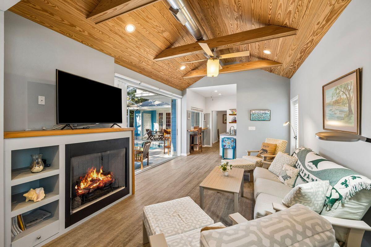 In the heart of Seagrove, just steps from the sand, local dining, shopping and the 30A bike path, this beautifully updated beach cottage offers the kind of easy coastal living that makes every day feel intentional. With deeded beach access and use easement granted to Gulf Shore Manor property owners, the four-bedroom, four-and-a-half-bath residence places the best of 30A close at hand while preserving a sense of privacy at home.
Inside, natural light fills the open-concept kitchen, living and dining areas, creating an inviting setting for everyday comfort, relaxed entertaining and time spent together after a day at the beach. Tile flooring extends throughout the first floor, where the spacious primary suite offers a quiet retreat with a remodeled spa-inspired bath featuring a walk-in shower, soaking tub and soapstone countertops. An additional first-floor bedroom and bath, with gas fireplace, enhances the home's flexibility for guests, extended family or multi-generational living.
The kitchen is both polished and practical with soapstone countertops, a Kohler sink, gas range and generous workspace designed for gathering. Outdoors, the private heated saltwater pool, expansive pool deck, separate hot tub and covered eat-up bar area create a resort-style setting made for slow mornings, sunny afternoons and casual evenings under the palms. A newly built outdoor shower, completed in 2025, adds another thoughtful touch for beach days. Beautiful landscaping, privacy shrubs, strong curb appeal and a paver circular driveway with additional side parking complete the setting, while a large outdoor storage shed offers ample room for bikes, beach gear and pool essentials. Additional features include a tankless water heater, abundant storage and a highly sought-after Seagrove address along Scenic Highway 30A. Never rented by the current owners, this inviting cottage is well-suited as a primary residence, second home, or vacation rental opportunity in one of 30A's most walkable coastal enclaves.
