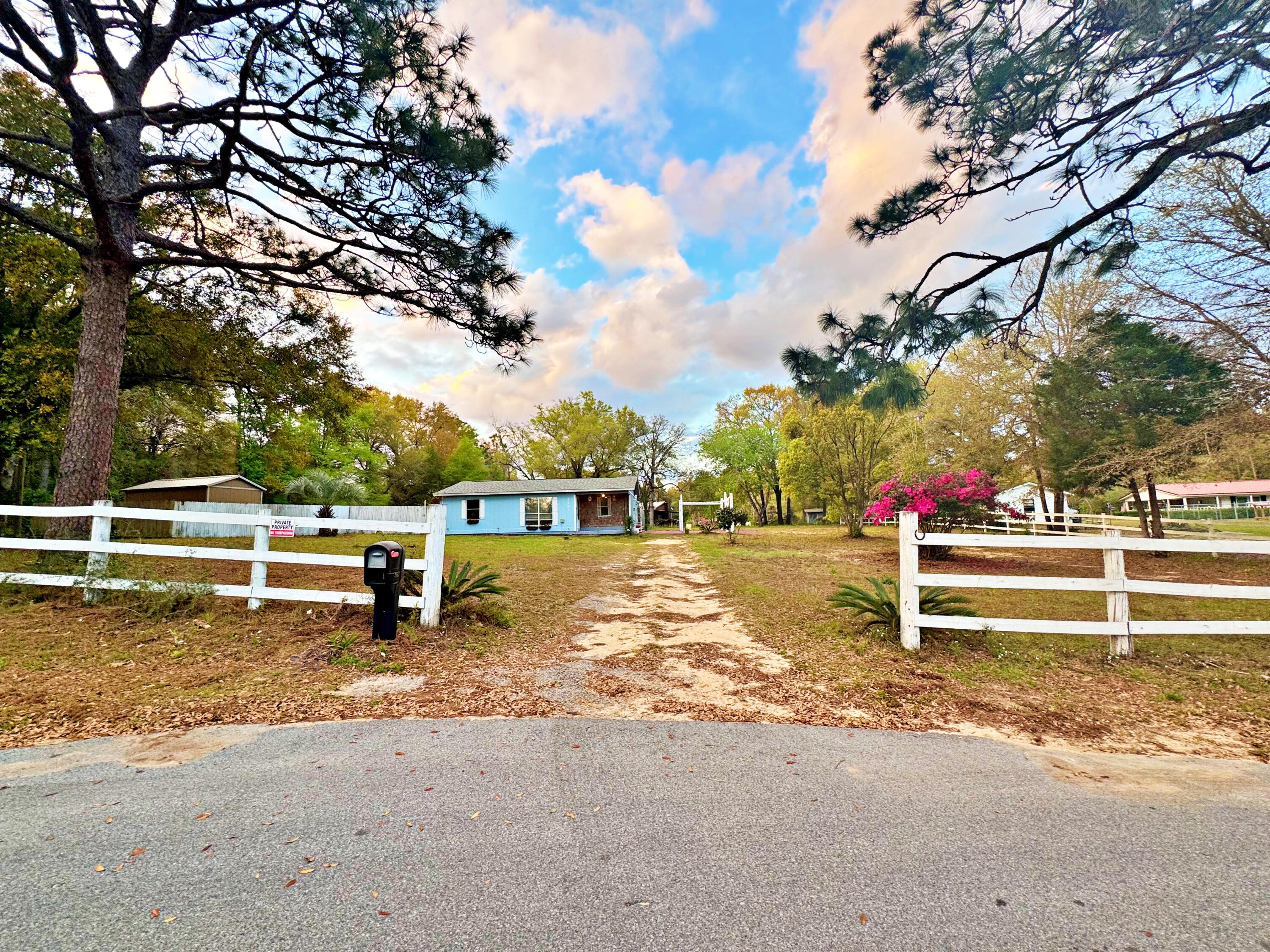 Welcome to this inviting 2-bedroom, 1-bath ranch on a private 1.00-acre lot in North Crestview. Features include a covered front patio, fenced in dog run, spacious living area, open dining/kitchen layout, and two well-sized bedrooms. Gracious storage shed directly behind the home. Roof and water heater was updated in 2020, flooring throughout was updated in 2023, and new HVAC installed Oct 2024.  Move in ready!