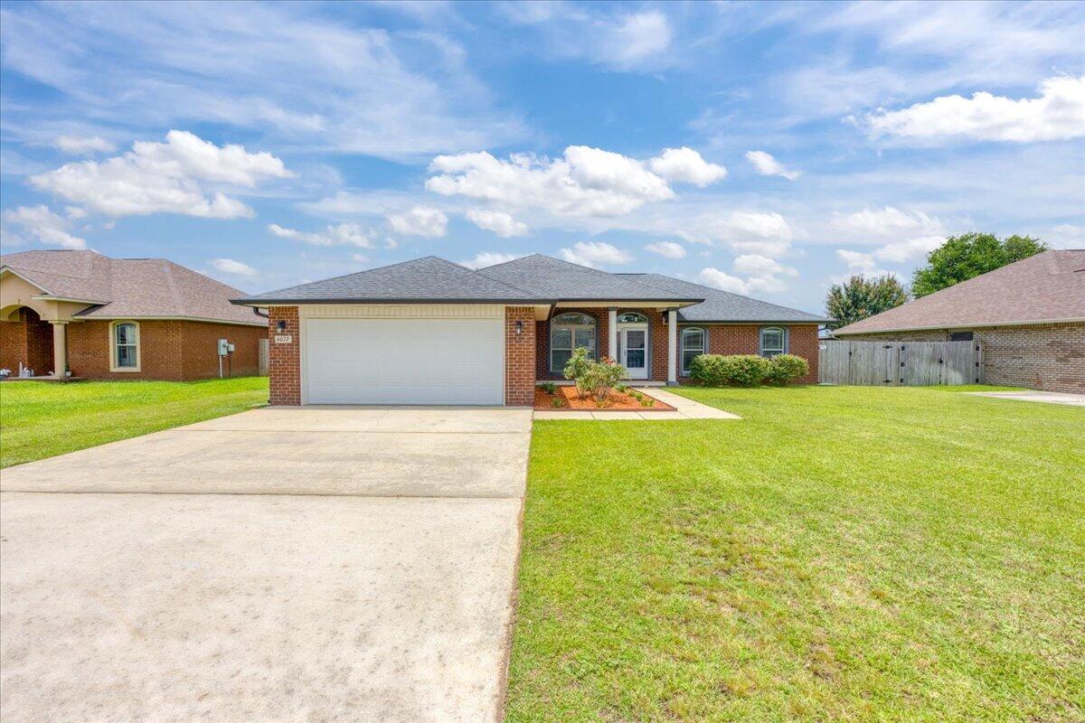 MOTIVATED SELLER! Built in 2017 and located in the well-maintained Holley-Cliff Estates community, this brick 4-bedroom home offers the benefit of no HOA while providing convenient access to shopping, schools, NAS Whiting Field, and NAS Pensacola! Inside, the open living room features vaulted ceilings, a fireplace, and abundant natural light, creating a spacious gathering area. The kitchen is thoughtfully designed with custom maple cabinetry, granite countertops, stainless steel appliances, a large pantry, and multiple dining options including a breakfast bar, bay-window breakfast nook, and formal dining area! The split-bedroom floor plan provides privacy for the primary suite, which features a tray ceiling and a spacious ensuite bathroom complete with a granite double vanity, garden tub, separate shower, private water closet, two walk-in closets, and linen storage. Three additional bedrooms are located on a separate hallway and feature hard-surface flooring with no carpet. A shared guest bathroom, dedicated laundry room, and two-car garage equipped with a mini split for climate control add to the home's functionality. Step outside to a covered patio overlooking the fully fenced backyard. The outdoor space includes a sprinkler system and a 10' x 20' storage shed (with power available), providing plenty of room for equipment, hobbies, or additional storage. Also included is a partial generator that runs on gas. Move-in ready and exceptionally maintained, this home combines qua lity finishes, practical living spaces, and a desirable Milton location and neighborhood!