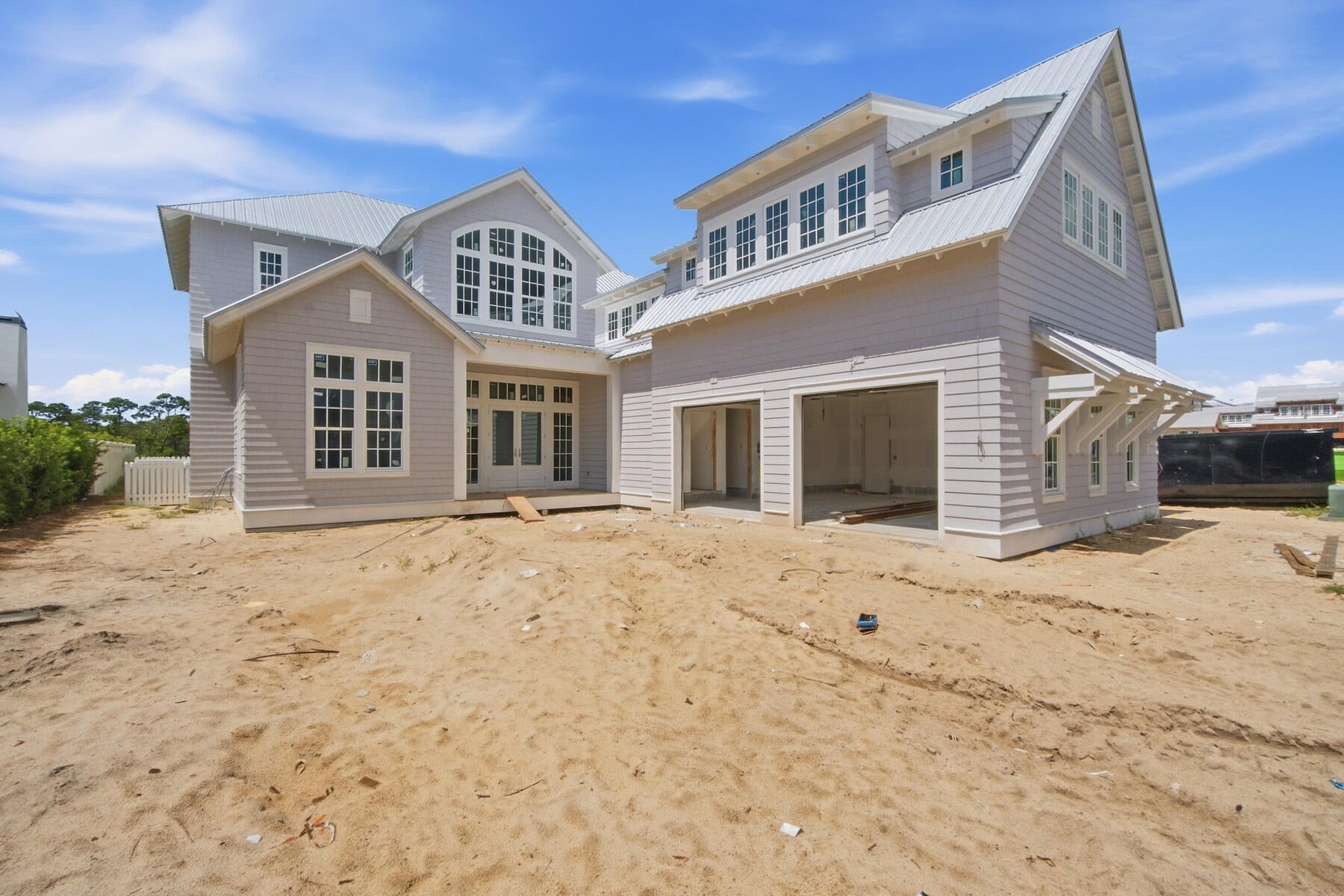 The Darien III by Romair is a custom residence with a detached carriage house, offering 4,775 square feet, 5 bedrooms, 5 bathrooms, 2 half baths, and an oversized  2-car garage, located on a Homesite backing up to vast open green space in Powell Landing East at Watersound Origins.

The first level is arranged with clearly defined spaces, beginning with a dedicated dining room that includes a built-in wet bar and under counter wine refrigeration. The kitchen is positioned at the rear of the home, opening directly to the covered porch and summer kitchen, creating a direct connection to the outdoor living areas and pool courtyard . The adjacent living room features a fireplace and 16 foot slider doors that open fully to the exterior, extending the living space outward. Twelve-foot ceilings throughout the main level reinforce the scale of each space without sacrificing proportion.

The owner's suite is located on the main level with French doors leading directly to the pool and spa. The bath includes a walk-in shower with upgraded rain fixture shower head and expanded illuminated shower niche, a free-standing soaking tub, along with a spacious custom closet designed with a center island for additional storage and organization .

Functional spaces are equally considered. The laundry room includes built-in cabinetry, a sink, a dedicated broom closet, and a bench with cubbies for everyday use. Circulation between the garage, and main living spaces is efficient and separate from guest-facing areas.

The second level with ten-foot ceilings provides additional bedrooms all with ensuite bathrooms and access to the rear balcony. A secondary living space with vaulted ceiling, offers separation from the main level while maintaining connection through a central stair hall. Above the garage, the carriage house includes a kitchenette, living area, bedroom, and bath with its own access, suitable for guests or extended stays.

The outdoor environment is fully integrated into the plan. A heated saltwater pool and spa with baja deck are set within a paver pool deck and enclosed by fencing, all managed by a WiFi-enabled pool controller. The cabana with fireplace anchors the space, while the dedicated outdoor kitchen connected to the main house is equipped with an Artisan grill with stainless steel doors, U-Line outdoor refrigerator, and sink.

Interior finishes include white oak cabinetry with stained overlay throughout, along with upgraded quartz surfaces and upgraded Delta plumbing fixtures. The home is equipped with a Water and Air Wellness Package, including a whole-house water softener, reverse osmosis system, REME Halo air cleaner, and an added integrated leak detection system.

Additional features include a tankless water heater and detailed interior trim consistent with the overall architectural design.

Estimated completion: Nov. 2026

As part of Watersound Origins, often called "A Coastal Village," residents relish abundant amenities like the Village Commons resort-style pool, fitness center, sports courts, miles of nature trails, event lawns, and the Origins Golf Course. Surrounded by towering pines and just minutes from Lake Powell and the beaches of Scenic Highway 30A, this community blends natural beauty with easy access to Inlet Beach, Grayton Beach, and beyond. Upcoming highlights include the 15.5-acre Longleaf Art Park, opening in 2027, featuring cultural and recreational experiences.