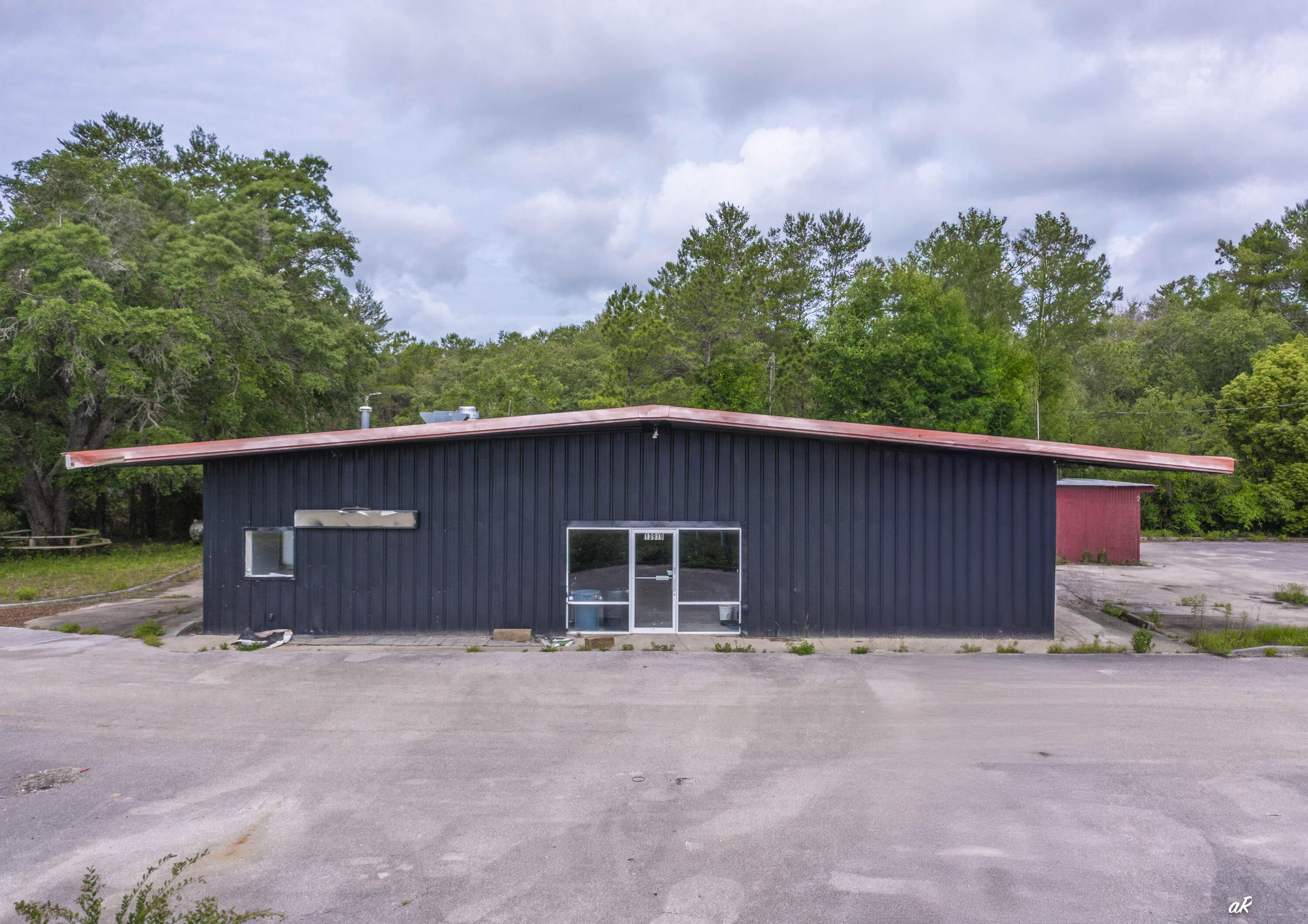 Position your business for success with this high-visibility commercial opportunity on rapidly growing Highway 77 in Southport. Situated on 1.24 acres with excellent frontage and dedicated ingress/egress access, this versatile steel-constructed building offers approximately 4,800 square feet under roof, including 3,600 heated and cooled square feet, along with ample parking and easy access for trailers, delivery vehicles, and customers. The property is currently undergoing renovations, with all improvements scheduled to be fully completed prior to closing, allowing the next owner to step into a refreshed and move-in-ready space. Designed with flexibility in mind, the building features a commercial-grade septic system sized for restaurant use, an existing kitchen hood system, drive-through capabilities, and a layout that can accommodate a wide variety of commercial uses including restaurant, retail, office, service-based businesses, or franchise operations. Located in one of Bay County's fastest-growing corridors, the property benefits from strong traffic counts, exceptional visibility, and continued residential growth throughout the area. A new residential community under development nearby will further contribute to the expanding customer base and long-term investment potential. Whether you're an owner-user seeking a strategic location or an investor looking for a property with strong future upside, 13919 Hwy 77 presents a rare opportunity to secure a highly  adaptable commercial asset in the path of growth. Schedule your tour today and discover the possibilities this property has to offer.