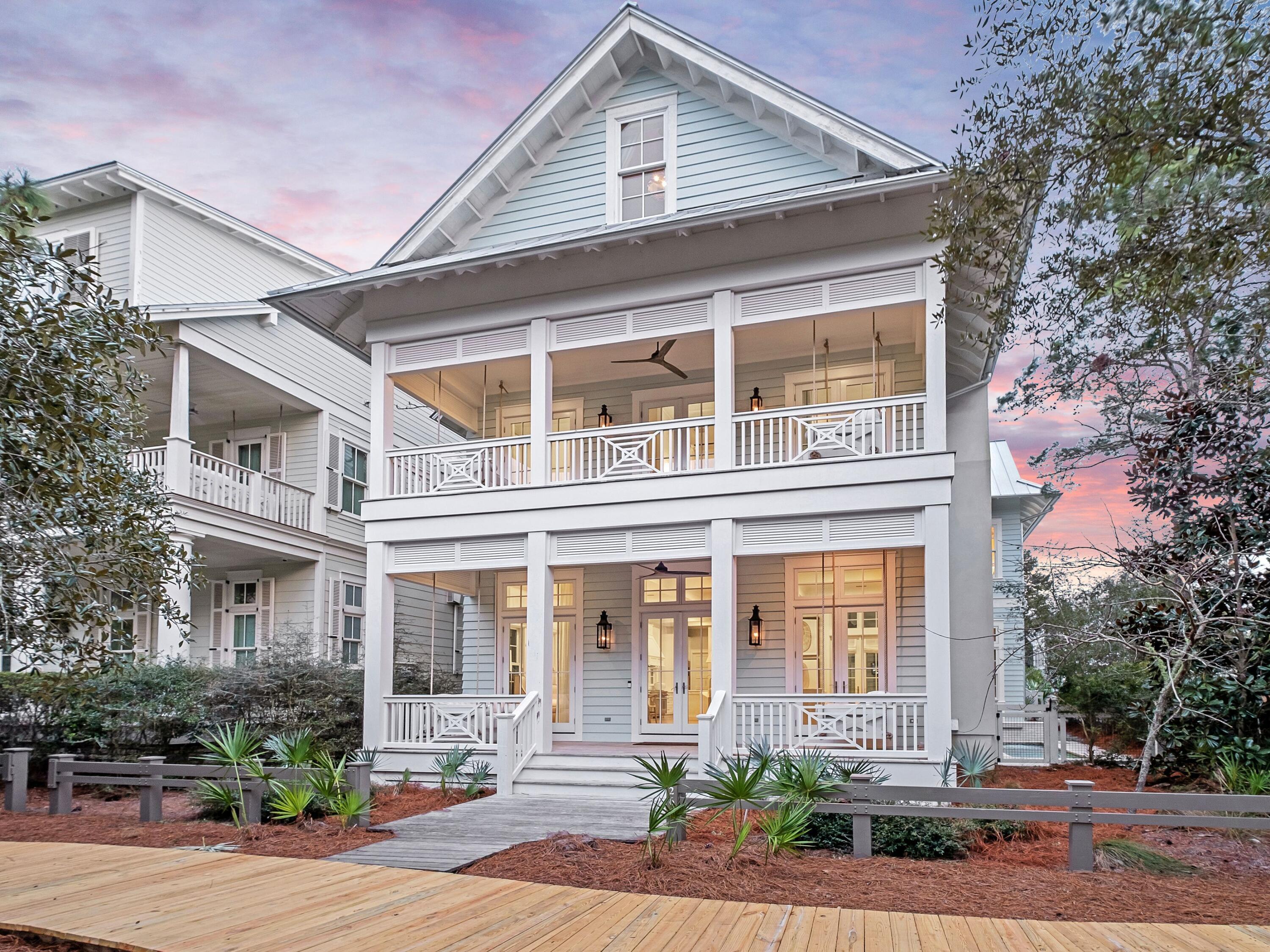 Situated in WaterColor's coveted Lake District, this exceptional six-bedroom, eight-bathroom residence defines coastal luxury at its finest. Professionally designed and offered fully furnished, the home delivers a seamless blend of sophistication, comfort, and proven rental appeal. Generating $388,479 in 2025 rental revenue with projections of $401,350 in 2026, this residence provides both a refined personal retreat and a strong investment opportunity. The open, airy floor plan was designed for both intimate gatherings and grand entertaining. Anchored by a gourmet kitchen with premium appliances, an oversized island, and custom cabinetry, the space flows effortlessly into the dining area and great room, where a fireplace, coffered ceilings, and designer finishes create a warm yet elevated atmosphere. Expansive glass doors dissolve the boundary between indoors and out, revealing a private outdoor sanctuary with a heated pool and hot tub, covered patio, and fully equipped summer kitchen, perfect for year-round entertaining.

All six bedrooms feature ensuite baths, offering privacy and comfort for guests and family alike. The second-level primary suite boasts a spa-inspired bathroom, private balcony, and expansive walk-in closet. This floor also includes an additional guest suite, a relaxed lounge area, and separate guest quarters complete with kitchenette, bath, and laundry ideal for extended visits.

Accessible via stairs or elevator, the third level features a charming bunk room, additional sitting areas, and extra sleeping accommodations, providing ample space for larger groups. Throughout the home, custom millwork, designer lighting, and curated finishes elevate every detail, reflecting meticulous craftsmanship and thoughtful design.

Ideally located near the WaterColor Beach Club, Camp WaterColor, scenic nature trails, and the boutiques and dining along 30A, this residence offers an unparalleled lifestyle. Whether enjoyed as a full-time home, a luxurious coastal getaway, or a high-performing investment property, 26 Rain Lily Lane stands as a true masterpiece of design, comfort, and coastal living.