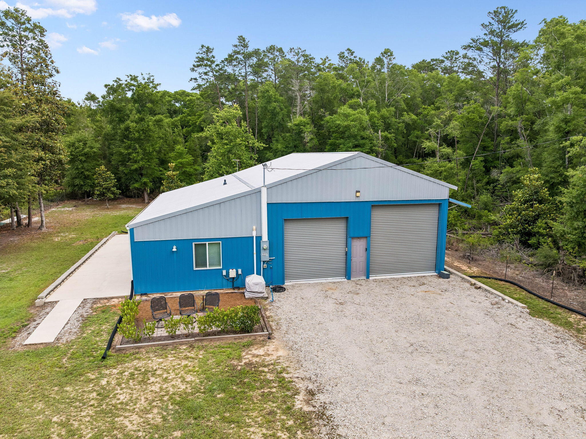 Rare find! This heavy-duty 1 bedroom/2bonus room/2 full bathroom home features 912 sq ft of living space (2,300 total sq ft) built on a monolithic slab with high-efficiency 2x6 spray-foam construction and 140-mph storm-certified windows and doors. The interior is open space, plentiful storage, 8-14' ceilings, solid wood kitchen cabinets, large laundry room. The ultimate 30x38x14' garage boasts a 12x30 storage loft, two hurricane doors (12x12 & 10x10), and a robust 200-AMP electrical service with two 100-AMP sub-panels. Boat or RV can be parked on the additional 12x50 concrete patio. Fully fenced backyard. Perfect for hobbyists, boat/RV owners, or anyone wanting .50 acre of land with lots of outdoor space.