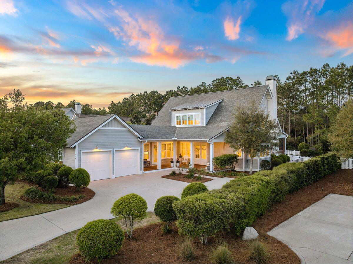 Located in the established area of WaterSound Origins, this highly sought-after Weatherly floor plan by Romair Homes sits on an exceptionally private homesite backing to a serene nature preserve. This Cape Cod-inspired home offers 4 bedrooms plus bunks, 4.5 baths, including a primary suite on the main level, combining timeless design with everyday functionality.
You are welcomed by a charming front porch complete with a quintessential porch swing, setting the tone for relaxed coastal living. Offered fully furnished, this home presents a turnkey opportunity for buyers, adding immediate value and ease of ownership.