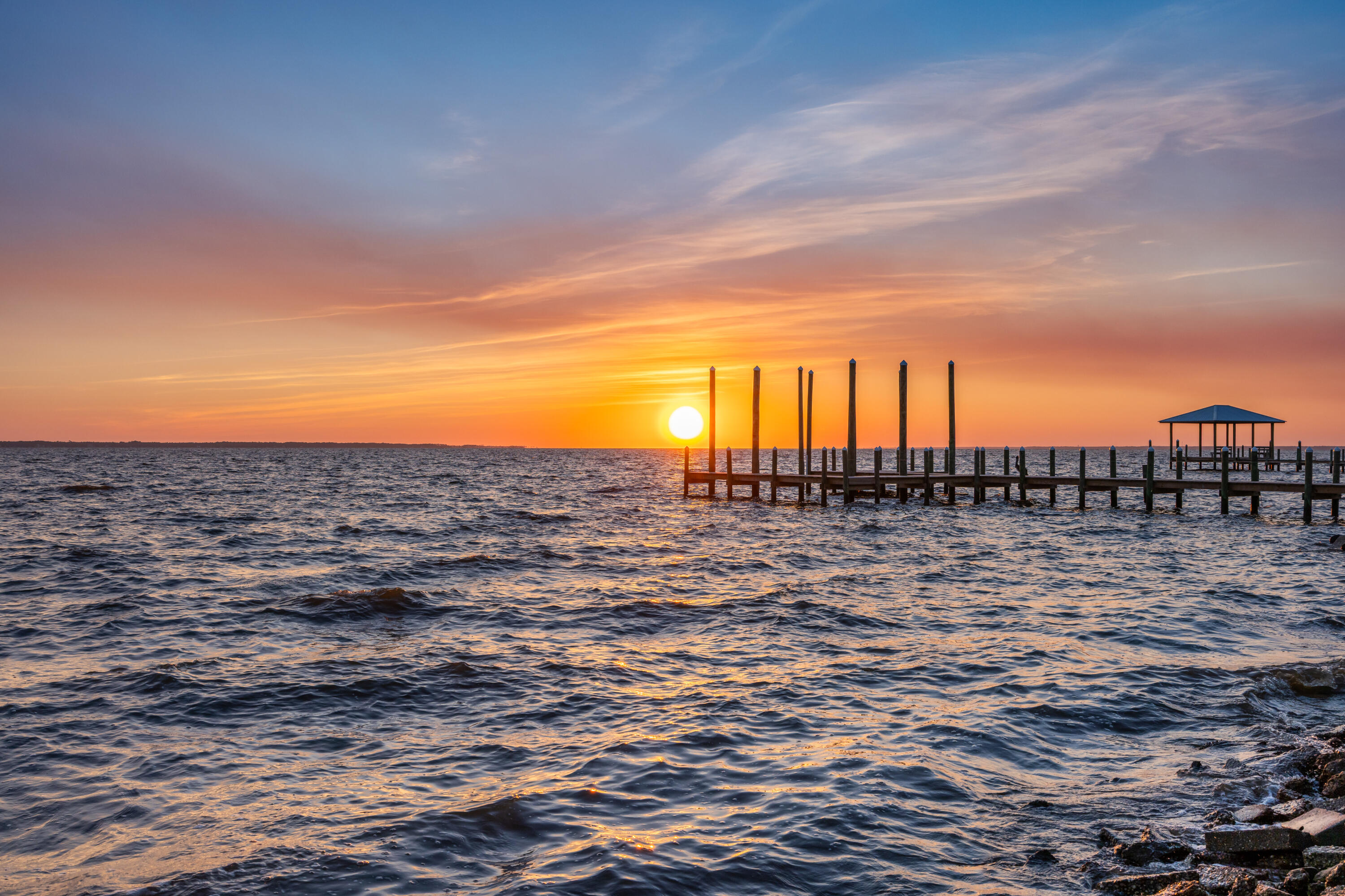 Extraordinary Views!!! 
A Waterfront Dream on Choctawhatchee Bay

As the morning sun rises over Choctawhatchee Bay, golden light dances across the water, painting the sky in shades of pink and orange. The soft sounds of waves gently lapping against the shore create a peaceful rhythm—this is the kind of serenity that awaits you every single day.

Nestled along 147 feet (approx.) of pristine waterfront, this rare, cleared, and level lot is a true hidden gem. A quaint 2-bedroom, 1-bath cabin sits on the property, waiting for the right vision to bring it back to life. Whether you dream of restoring its charm or building something entirely new, the opportunity to create your own bayfront sanctuary is here. 

Step outside, and the possibilities are endless. The seawall and dock pilings are already in place, inviting you to rebuild a dock designed for memorable days on the water. Imagine launching your boat just steps from your door, setting out for a morning of fishing where Speckled Trout, Redfish, and Flounder await. In the afternoon, take a paddleboard or kayak across the bay, letting the salty breeze guide you toward adventure.

And when the day winds down, there's no better way to end it than with a front-row seat to the most breathtaking sunsets. Pour a glass of wine, settle in on the porch, and watch as the sky turns brilliant shades of crimson and gold, reflecting off the water in a mesmerizing display.

Just 200 feet away, Grady Brown Park offers even more to love about this location. With a sandy beach, a large boat ramp, a handicap-accessible kayak launch, picnic areas, and open green space, it's like having a private retreat right next door.

But the magic of this property extends beyond its beauty - it's also incredibly convenient. Located in a peaceful, welcoming community, you're just a short boat ride from North Beach Social and The Bay Restaurant, perfect for a waterfront dinner with friends. Freeport is minutes away, offering shopping and essentials, while the stunning beaches of 30A are only 15-20 minutes from your doorstep. And with quick access to Interstate 10 and the VPS & ECP airports, travel is effortless.

This is more than just a piece of land. It's a lifestyle, a retreat, a dream waiting to be realized. Whether you're looking for a weekend getaway, a permanent waterfront home, or an investment in a slice of paradise, this property offers everything you could want.
Why wait? The sunrises are calling, the bay breeze is whispering, and the chance to live your dream is right here. Come see it for yourself--your waterfront story begins today!