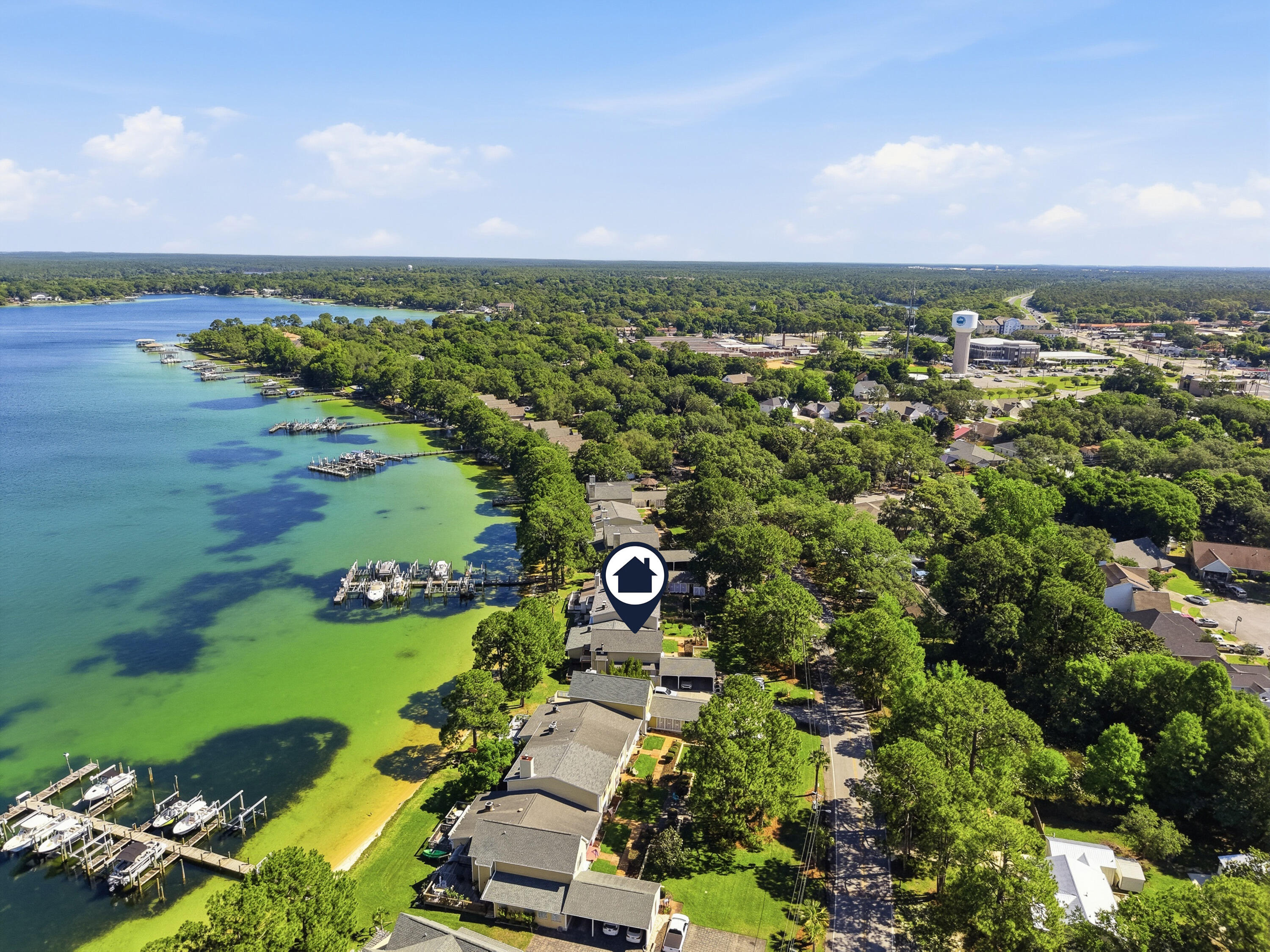 Your waterfront ownership dreams can come true! This waterfront townhome on the Bayou in Garnier's Cay with beach access from your back door AND a private boat slip is now available for a new owner! This beautiful home has been well cared for with updates throughout. With brand new exterior siding and upstairs balcony, a water heater and HVAC that were installed new in 2022, updated bathrooms, and a large oversized deck to enjoy your waterfront view you are sure to fall in love. You can store your boat right out back in a slip that measures 20' x 12.5' and also enjoy paddle boarding out your back door with a natural beach located right behind your back porch. Downstairs you will find a bright and open floor plan with a kitchen bar, wet bar, fireplace and downstairs half bathroom for convenience. Upstairs your primary bedroom overlooks the water with a balcony to enjoy the view and look for dolphins every morning. There is also another nice sized bedroom upstairs, also with its own en suite bathroom. Located in close proximity to shopping, our local military bases, great schools, dining and the beautiful beaches of Northwest Florida, reach out to make an appointment to see this home today!