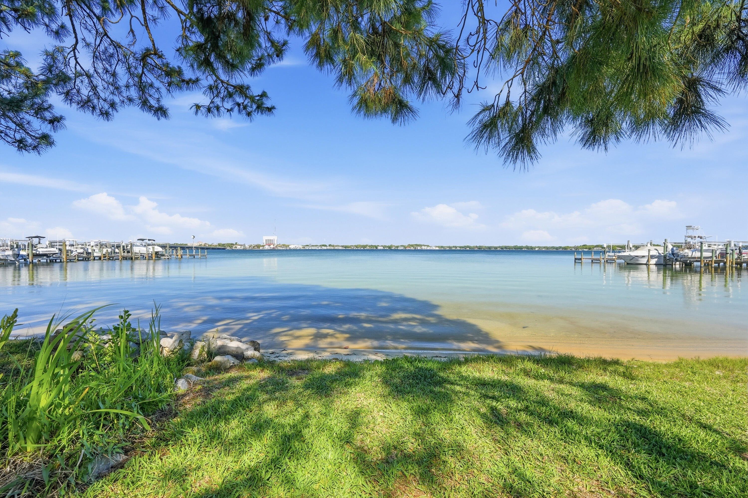 Want to keep your boat only steps from your back porch overlooking the beautiful bayou? Here is your chance, your waterfront ownership dreams can come true! This waterfront townhome in Garnier's Cay with beach access from your back door AND a private boat slip is now available for a new owner! This beautiful home has been well cared for with updates throughout. With brand new exterior siding and upstairs balcony, a water heater and HVAC that were installed new in 2022, updated bathrooms, and a large oversized deck to enjoy your waterfront view you are sure to fall in love. You can store your boat right out back in a slip that measures 20' x 12.5' and also enjoy paddle boarding out your back door with a natural beach located right behind your back porch. Downstairs you will find a bright and open floor plan with a kitchen bar, wet bar, fireplace and downstairs half bathroom for convenience. Upstairs your primary bedroom overlooks the water with a balcony to enjoy the view and look for dolphins every morning. There is also another nice sized bedroom upstairs, also with its own en suite bathroom. Located in close proximity to shopping, our local military bases, great schools, dining and the beautiful beaches of Northwest Florida, reach out to make an appointment to see this home today!