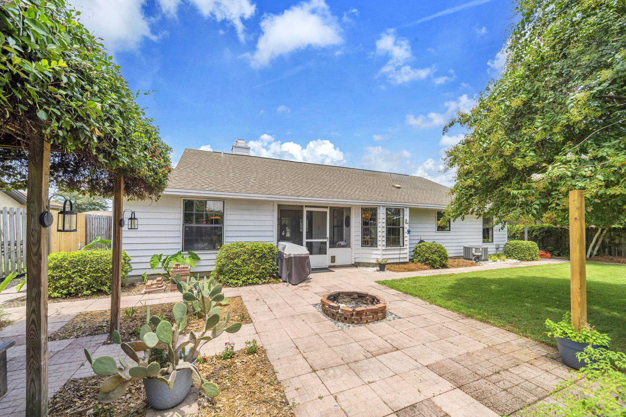 Perfectly positioned in the heart of Destin, this charming 2-bedroom, 2-bath home offers 1,342 square feet of comfortable living space with no HOA and an unbeatable location just minutes from the beach, top-rated schools, the Destin Library, city parks, local restaurants, shopping, and everything the Emerald Coast has to offer.

Inside, you'll find a bright and inviting floor plan featuring tile flooring throughout, abundant natural light, and a spacious living room anchored by a cozy brick fireplace. The eat-in kitchen is designed for both everyday living and entertaining with granite countertops, tiled backsplash, breakfast bar, and ample cabinet space.

The generous primary suite features a walk-in closet and an updated ensuite bath complete with a beautifully remodeled tiled shower, updated vanity, and stylish barn door. The secondary bedroom enjoys convenient access to the second full bathroom, making it ideal for guests or family.

One of the home's most versatile spaces is the oversized mudroom/laundry room, currently used as a home office. Previously utilized as a third bedroom, this space could easily be converted back if desired, with the washer and dryer previously located in the garage--offering flexibility to meet your changing needs.

 Step outside to your own private backyard retreat featuring a screened porch, covered patio, pergola, fire pit, and a large privacy-fenced yard--perfect for entertaining, relaxing, or enjoying Florida's year-round outdoor lifestyle.

Additional updates include a new HVAC system and water heater installed in 2020, providing added peace of mind. Whether you're looking for a primary residence, second home, or investment property, this move-in-ready home combines location, functionality, outdoor living, and the freedom of no HOA in one of Destin's most convenient neighborhoods. Buyer to verify all information