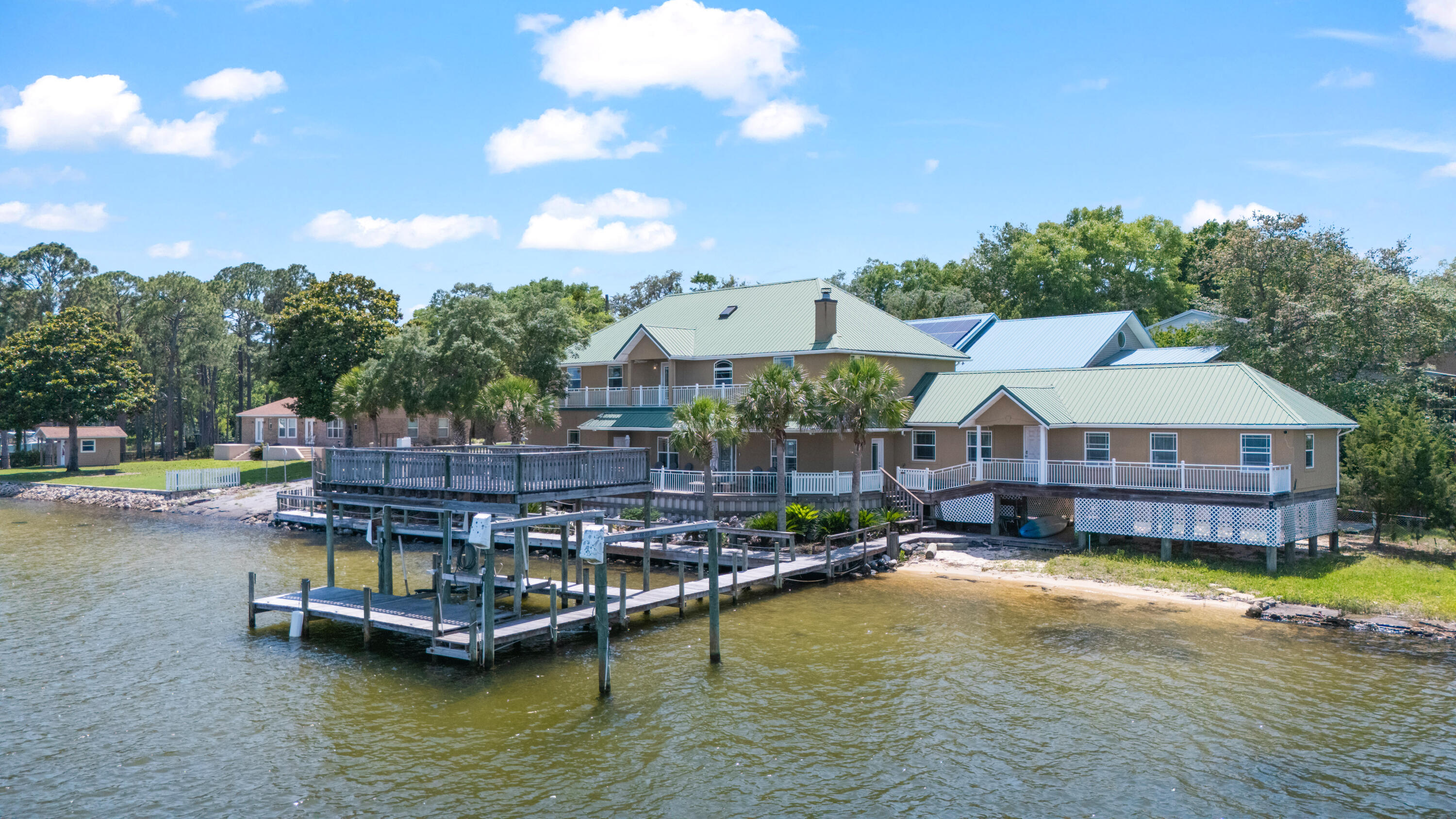Welcome to 1747 18th Street in Niceville, an exceptional waterfront property offering over 200 feet of frontage on Sarah Ann Bayou and Rocky Bayou with direct boating access. This spacious 5-bedroom, 5-bath home features approximately 4,575 square feet designed for entertaining, relaxing, and enjoying the ultimate waterfront lifestyle.

Arrive by car or boat to a DEEP WATER private dock capable of accommodating multiple boats and watercraft, making this property a dream for boating enthusiasts. Inside, the open-concept floor plan features elegant crown molding, expansive living spaces, and abundant natural light throughout.

The chef-inspired kitchen includes double ovens, stainless steel appliances, custom bamboo cabinetry, and beautiful bamboo hardwood flooring -- perfect for hosting family and friends. The main-level primary suite offers a private waterfront retreat with direct access to the backyard oasis.

Whether you're searching for a luxury primary residence, vacation home, multigenerational property, or waterfront investment opportunity, this remarkable home combines space, comfort, and stunning bayou views in one of Niceville's most desirable locations.