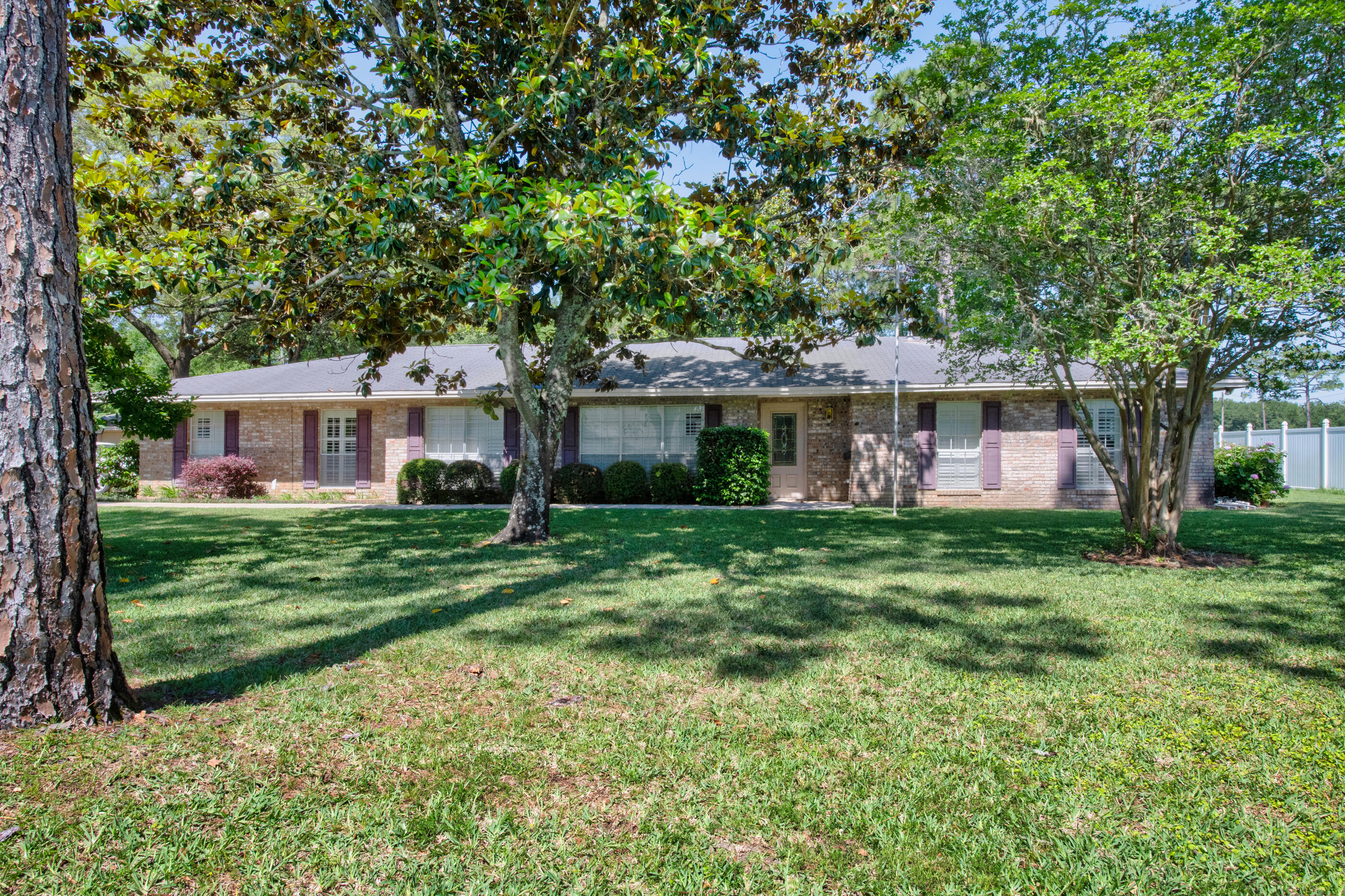 Mother-In-Law Suite!! 645 NE Country Club offers a rare opportunity to own a spacious home on a half-acre lot in one of Fort Walton Beach's most established and sought-after areas... all with no HOA to worry about. Set on a beautiful park-like lot surrounded by mature magnolia trees, this property delivers the kind of setting that is becoming harder to find--large, private, and full of character. Enjoy peaceful golf course views from your backyard while cooling off in your private pool, creating a space that feels like your own everyday retreat.
Inside, you'll find generous living spaces designed for flexibility and function, including a desirable mother-in-law suite ideal for multigenerational living, extended guests, a private home office, or additional income potential. The home's layout offers room to spread out, entertain, and truly make it your own.
While some areas present an opportunity for modern updates and personal touches, the home showcases timeless features, substantial square footage, and the strong foundation homeowners are looking for. The possibilities here are endless for someone wanting to blend today's style with an established home's size, location, and character.
Conveniently located near Eglin Air Force Base and Hurlburt Field, with easy access to shopping, restaurants, schools, and the white-sand beaches of the Emerald Coast, this location is ideal for military families, commuters, and anyone wanting to enjoy the best of Fort Walton Beach living, Half-acre lots, established neighborhoods, golf course views, a private pool, no Homeowner's Association, and room to grow are becoming increasingly difficult to find. Space, location, views and opportunity all come together here in a property ready for its next chapter.