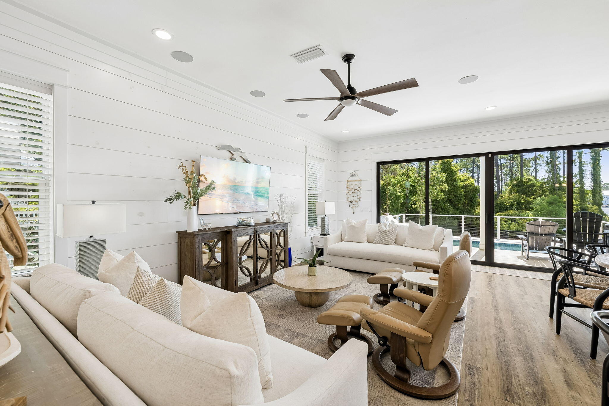 Set along Eastern Lake dock and the sound of the surf drifting in from nearby beach access, this spacious Seagrove Beach retreat brings together coastal ease, modern comfort and an exceptional lakefront setting south of Scenic Highway 30A, 600' from the Gulf. Built in 2022, offering 3,754 square feet of interior living space with five bedrooms, four-full-and-one-half bath, creating a generous layout designed for gathering, relaxing and enjoying the best of life near the water. Inside, high ceilings, shiplap walls, wood floors, custom cabinetry and bright coastal finishes create a refined yet relaxed atmosphere throughout. Four large bedrooms feature ensuite baths, while a bunk room adds flexible sleeping space for guests or family, allowing the home to comfortably accommodate up to 14. The open living, dining and kitchen areas are arranged for easy entertaining, with dining for 10 and bar seating for four. Outdoor living is a defining feature, with two large porches, a private heated pool, expansive pool deck, fenced yard and dock overlooking Eastern Lake. Start the morning with coffee by the water, spend the afternoon at the beach just 200 yards away, then return for an evening swim or sunset views from the porch. Additional conveniences include a two-car garage, parking for four vehicles and smart TVs in every room. With shopping, dining, entertainment and beach access all within 2 blocks, this lakefront home offers a rare combination of space, setting, views and amenities. walkability in the heart of Seagrove Beach.