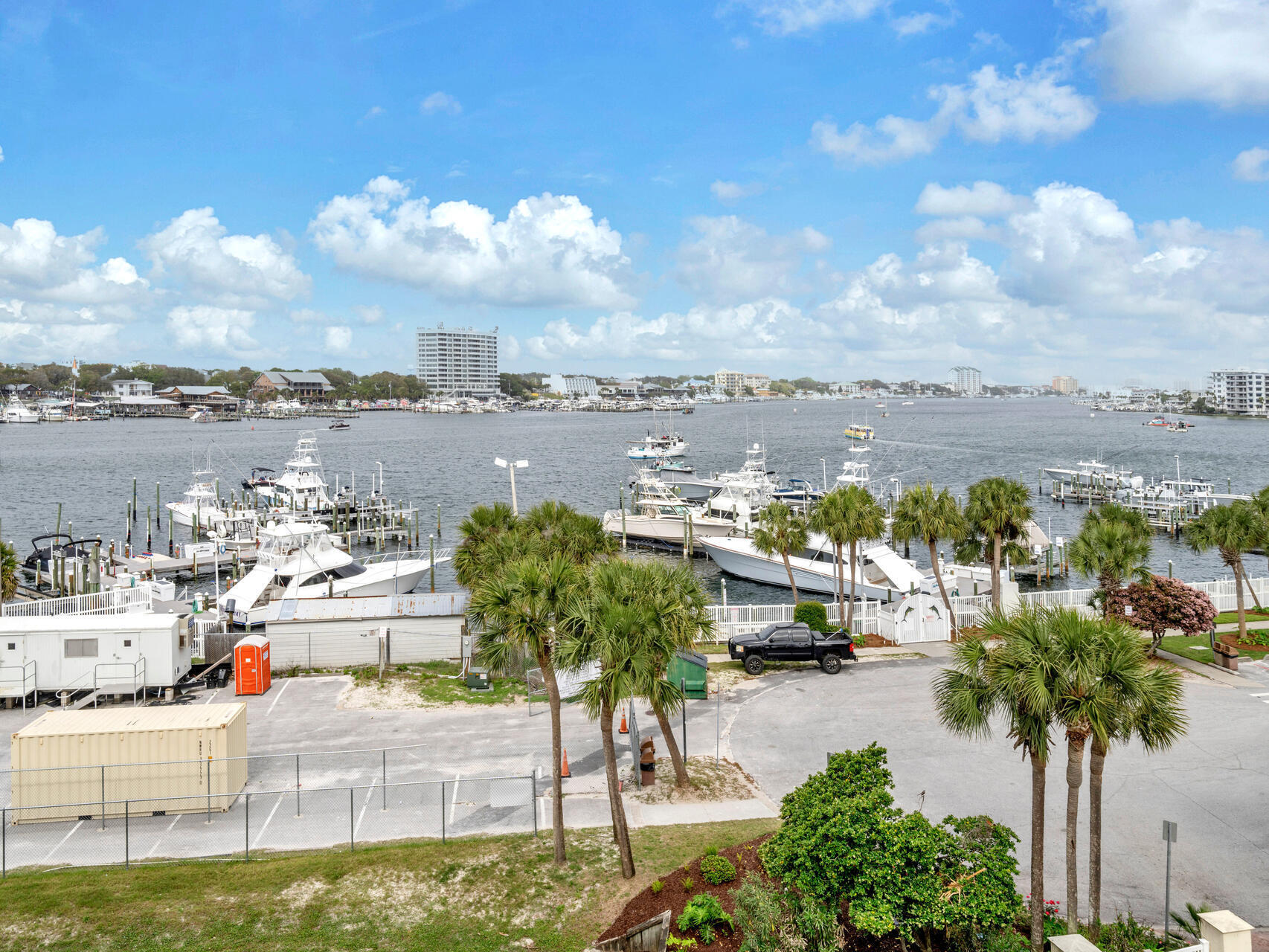 Welcome to East Pass Towers, Unit 403 with 2 bedrooms and 2 baths and 1500 sq ft. This unit has panoramic views of the Destin Harbor.  In addition, the NEW Norriego Point Park is nearby, Destin, Florida's newest public beachfront park! This park has soft white sandy beaches, extra parking, beach boat and jet ski parking, and is used by scuba divers! The park is beautiful and is a short distance from the condo. East Pass Towers is a gated community and is located at the end of Holiday Isle and offers Gulf, East Pass, and Harbor views! This condominium has one of the best locations for watching dolphins, boat traffic, and fireworks! There are not many condominiums that offer all three views! Also, there is a resort, style pool, hot tub, fitness center and community room. There is more! The condo has just refurbished the pool and hot tub and has remodeled the Club Room with a kitchen! The Fitness center is getting remodeled now! All assessments have been paid! The unit has a dedicated, garage parking spot! This is very important in the busy season! Park your vehicle or golf cart in this space. Every owner is allowed two parking spaces! There is a private marina with boat slips for sale across from the condominium! If you don't have a boat, don't worry! You can take a water taxi to dinner at popular restaurants such as Boshamps, Harbor Docks and AJs on the Harbor! Destin, Florida is a boat to table community! The unit is one of the largest 2 bedroom unit and offers a large living room space (30'x15') space with a built in office. The unit also has a balcony that (465 sq ft) provides breathtaking views of the Destin Harbor. There is an open floor plan with the kitchen opening to the dining area and living room. All of these areas plus the primary bedroom have waterfront views! The kitchen has a raised breakfast bar that seats 4, stainless appliances, built in microwave, slide in stove and oven. The dining room is spacious and overlooks the harbor! There is also a dedicated coffee or wine bar with cabinetry and a beverage refrigerator. There are two primary bedrooms with space for king sized beds. One primary bedroom has an ensuite bathroom. The primary bathroom has custom cabinetry with crown, a walk in shower, soaking tub, and spacious vanity. The guest bedroom is very spacious! This condo is being sold furnished. In addition there is a full guest bathroom and a laundry space. There is tiled flooring in all areas but the bedrooms. This unit is perfect for a primary home, second home or vacation rental. The condo association is well funded and managed! The assessments have been paid and the condo has already completed and past the SIRS inspection! Watch the sunrises from your condo, enjoy exciting evenings with fireworks over the harbor during the summer, relax on the dedicated white sandy beach of the condo, or take a boat to dinner! This condo offers water front living at it's finest! Come enjoy the beautiful, white sandy beaches of the Gulf, East Pass, and Harbor! Owners are allowed to have pets! There are several public beach access within minutes from East Pass Towers. Buyers to verify all information and dimensions. East pass unit 403 has a storage unit that is aprox 4x8 /4x10.