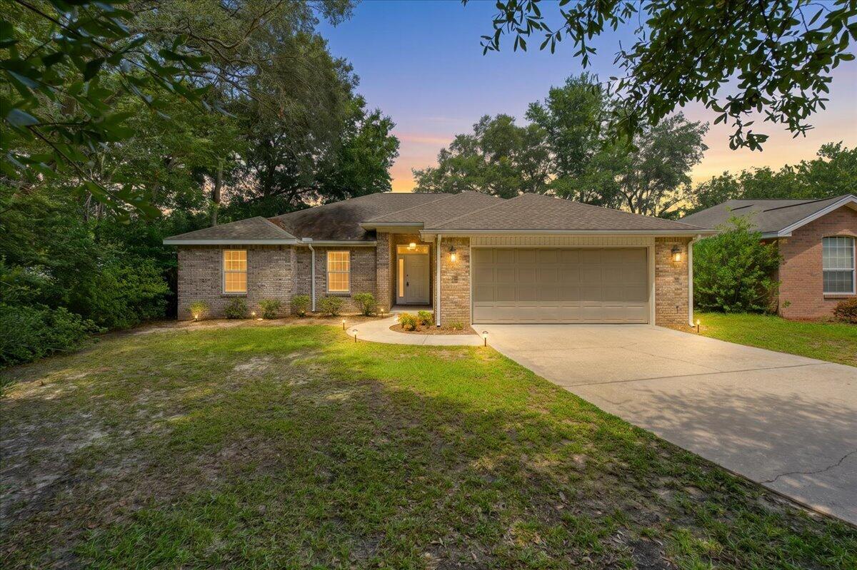 Welcome to 105 Underwood Lane, an inviting brick home nestled on a private cul-de-sac in the heart of highly desirable Niceville, Florida. This charming 3-bedroom, 2-bathroom residence is perfectly situated just minutes from top-rated schools, convenient shopping, and the world's most beautiful beaches, making it the ideal place to call home. Step inside to discover spacious raised ceilings and updated luxury vinyl plank flooring that flows seamlessly throughout the main living spaces. The great room features a cozy gas fireplace, providing a perfect setting for relaxing evenings or entertaining friends. Glass sliders open onto a screened-in back porch, ideal for enjoying your morning coffee or hosting summer barbecues. Home chefs will love the well-equipped kitchen, complete with abundant cabinetry, gleaming granite countertops, and modern appliances. An oversized laundry room adds practicality and convenience to your daily routine. Enjoy peace of mind with a brand new garage door, sprinkler system, and a 6ft privacy-fenced backyard, perfect for play, pets, or simply unwinding in your own outdoor oasis. With its thoughtful updates and unbeatable location, 105 Underwood Lane offers the perfect blend of comfort, convenience, and style. Don't miss your chance to own a piece of Niceville paradise. Schedule your private showing today and discover why this move-in ready home should be your next address! Buyers to verify items of importance such as measurements and school zones. New White garage door has been ordered and will be installed.  Roof is 2019, WH is 2021 and HVAC is 2012.