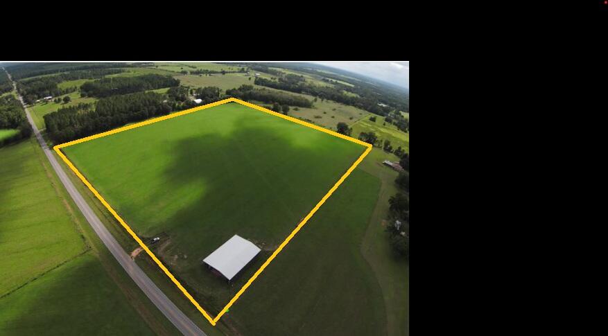 28.57 totally cleared acres. Property is High and Dry.  Fenced and gated. A 5,000 sq.ft., professionally installed, steel building with a 16' x 100' wing down one side. The property has power and water on site with 998' paved road frontage on State Hwy 393. This beautiful property is conveniently located approximately 14 miles north of Hwy 90 and just a short drive to the beaches of the Emerald Coast.