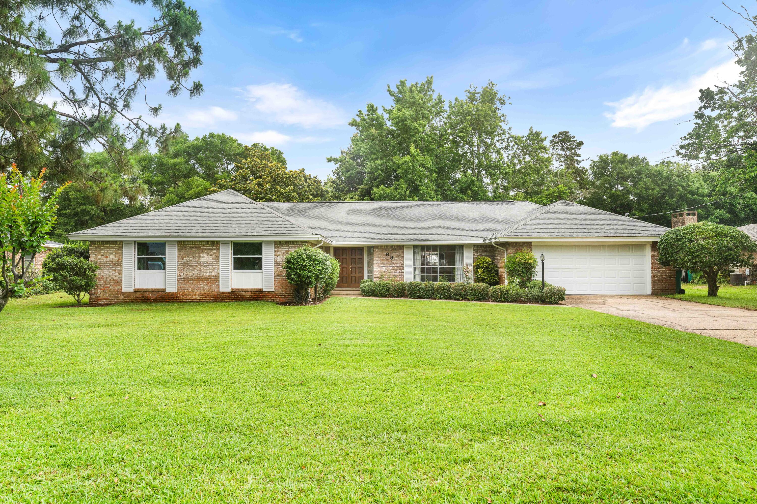 Nestled on a private 0.34-acre lot backing to the protected Eglin Air Force Base reservation, this beautifully maintained brick home offers exceptional privacy, mature trees, and no HOA restrictions. Conveniently located near top-rated elementary and middle schools, Meigs Park boat ramp access, shopping, dining, and all that Shalimar has to offer.
Inside, you'll find thoughtful upgrades and abundant storage throughout. The updated kitchen features elegant Carrara marble countertops, solid wood cabinetry, a convection oven with induction range, built-in spice rack, lazy Susan, pull-out shelves and drawers, and specialized pot-and-pan storage with a hidden drawer. Storage continues into the laundry room, where an impressive 11-foot wall of custom cabinetry with pull-out shelves and drawers provides incredible organization.

The home's spacious floor plan includes an oversized bonus room perfect for a pool table, game room, home office, or additional living space. Quality finishes throughout include bamboo wood flooring, Fusion Pearl tile, crown molding, and energy-rated windows that enhance both comfort and efficiency.

Step outside to enjoy the private backyard from the travertine-tiled patio, surrounded by mature landscaping and peaceful natural views. A storage shed provides additional space for tools and outdoor equipment.

Major updates include:

New electrical panel (2025)
New well pump (2025)
New dishwasher (2025)
Water heater (2023)
Wind-rated garage door (2023) This move-in ready home combines modern updates, abundant storage, a desirable location, and a rare private setting in the heart of Shalimar. Additional 6 gallon water heater for sink area. 
Schedule your private showing today and discover everything this exceptional property has to offer.