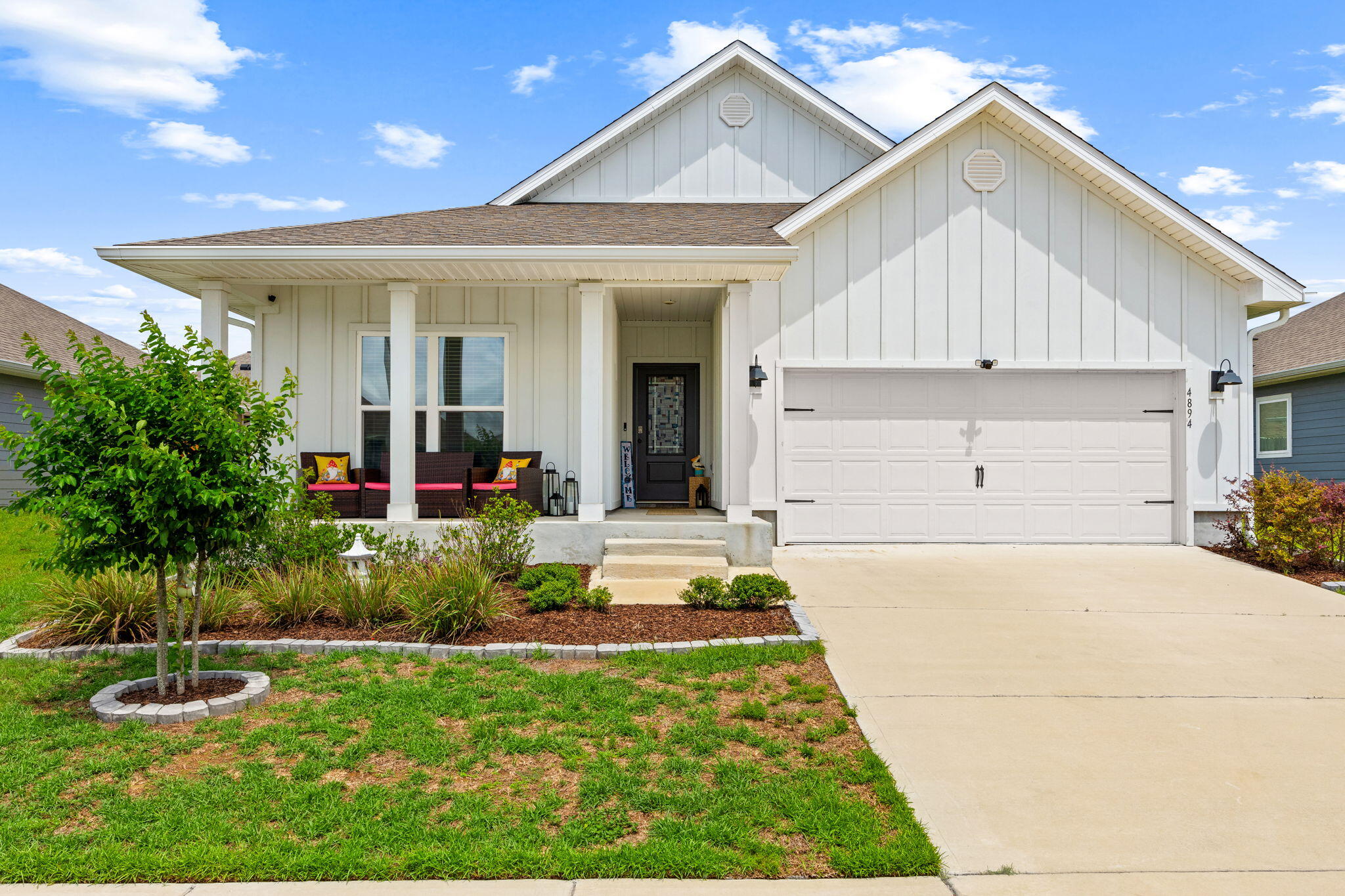 Beautifully designed Delray floor plan located in the desirable Titus Park community! Offering 4 bedrooms, 2 bathrooms, and over 2,000 square feet of thoughtfully designed living space, this 2023-built home combines functionality, comfort, and style in one of the area's most convenient locations. Enjoy a charming covered front porch, Hardie board siding, and a beautifully landscaped sidewalk-lined community featuring a community pool and convenient access to Publix, North Bay Haven Charter Academy, and the Hwy 231 corridor for an easy commute throughout town. Inside, the home features a bright open-concept layout with tall ceilings and a spacious living, dining, and kitchen area designed for everyday living and entertaining. The kitchen offers white cabinetry, a large center island, ample countertop space, and abundant storage. The split bedroom floor plan provides added privacy, with the primary suite tucked away at the back of the home. The spacious primary bathroom includes dual vanities, oversized countertop space, two separate closets, a water closet, and a large 5-foot shower. Near the front of the home, the flexible fourth bedroom located beside the oversized laundry room can easily function as a home office, flex space, or guest room depending on your needs. The laundry room itself offers additional storage space and functionality. Step outside to enjoy one of the home's standout features, a large screened and covered back porch overlooking the fully fenced backyard, creating the perfect space to relax and enjoy Florida living year-round.
