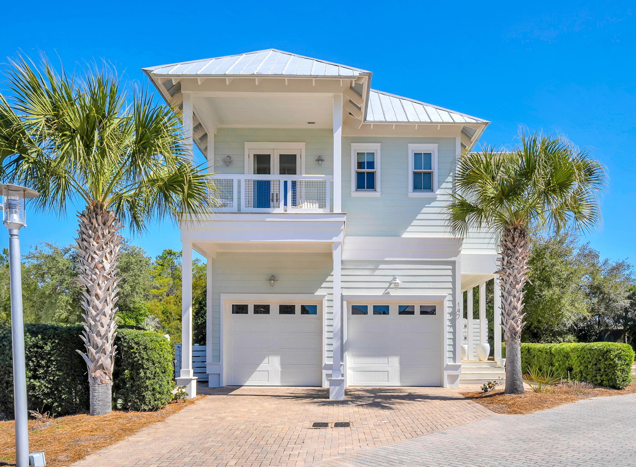 This stunning coastal retreat showcases a thoughtfully designed reverse floor plan, featuring an expansive master suite on the second level and two additional bedrooms with en suite bathrooms on the first floor. Both guest suites offer direct access to a covered porch and a fenced backyard, creating seamless indoor-outdoor living.
The private master suite serves as a peaceful sanctuary, complete with a generous walk-in closet featuring custom built-in shelving. Extending from the suite is a phenomenal porch overlooking a serene 150-year-old cypress pond -- the perfect setting for quiet mornings or breathtaking sunset views.
Upstairs, the reverse layout allows the home to fully embrace natural light and surrounding views. The second floor highlights a bright, open-concept kitchen, dining, and living area designed for effortless entertaining. A spacious private balcony at the rear of the home provides an inviting space for alfresco dining.
The beautifully appointed kitchen features an expansive island with ample seating, two pantries for exceptional storage, and a built-in wine refrigerator -- blending both function and style.
The adjoining den is enhanced by a cozy fireplace and a stunning vaulted ceiling that elevates the sense of openness. Abundant natural light fills the entire kitchen and living space, creating a warm yet airy atmosphere.
An oversized two-car garage adds practicality and convenience, offering generous storage along with a refrigerator, utility sink, and dedicated workbench area.
Located within the gated community of Cypress Dunes, residents enjoy premier resort-style amenities, including:
" Two resort-style pools (one featuring breathtaking Gulf views)
" A luxury clubhouse with chef's kitchen and entertainment lounge
" Fitness center
" Tennis and pickleball courts
" Outdoor fireplace and gathering spaces
" Scenic green spaces, walking trails, and picturesque boardwalks
This exceptional home blends refined coastal living with comfort, functionality, and elevated community amenities.
