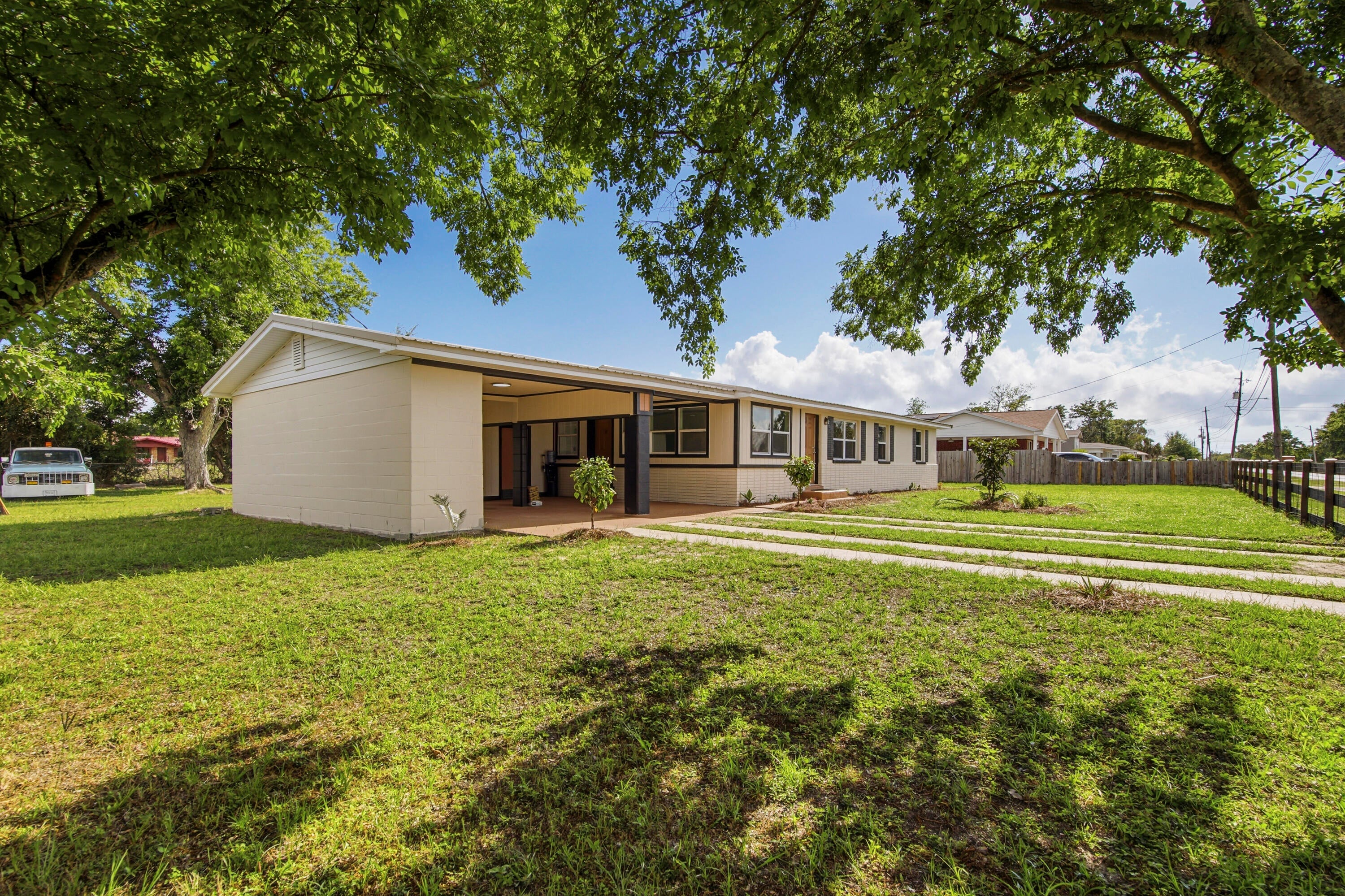 Opportunities like this are exceptionally rare -- a beautifully remodeled property with MIXED USE zoning that allows you to legally LIVE and WORK in the same space. Whether you're an entrepreneur, small business owner, creative professional, investor, or simply someone who wants flexibility for the future, this property delivers a lifestyle and business opportunity that's hard to duplicate. Perfectly positioned near Tyndall Air Force Base and just off busy Tyndall Parkway, the location offers both convenience and visibility with strong traffic counts for potential business exposure. Unlike standard commercial zoning, the Mixed-Use designation in this area allows residential occupancy -- giving you the freedom to operate a business without sacrificing the comfort of home. Inside, the remodel is nothing short of brilliant. Every inch of the space has been thoughtfully reimagined for maximum functionality, flow, and style. The main area of this home features a living room, dining area, remodeled kitchen with quartz countertops and new stainless appliance package and 2 bedrooms and 2 full baths, including a stunning newly created primary suite complete with an ensuite bath and walk-in closet. On the opposite side of the home, on the other side of the living room, there is a separate flex space with an oversized closet and an exterior door that walks out into the carport, which creates endless possibilities. Use it as a private third bedroom, client office, salon studio, creative workspace, consultation room, boutique, or home-based business -- all without clients or customers ever needing to enter your main living space. It's the ideal setup for maintaining both professionalism and privacy. Outside, the oversized corner lot adds even more value and versatility. The fully fenced yard with front and side gates provides security and functionality, while the drive-through carport and generous parking areas make access easy for personal vehicles, trailers, work trucks, or business clients. There's plenty of room here to truly make the property work for your lifestyle. Additional features include: huge corner lot with excellent accessibility; fully fenced with solar light post caps and multiple gated access points; large slab for the addition of a future shed; drive-through carport; working irrigation pump; flexible floor plan with residential and business potential; excellent visibility and convenience near shopping, dining, and Tyndall AFB; rare zoning flexibility in a rapidly growing area! This is more than just a remodeled home -- it's a smart lifestyle investment that gives you options, flexibility, visibility, and freedom all in one property.