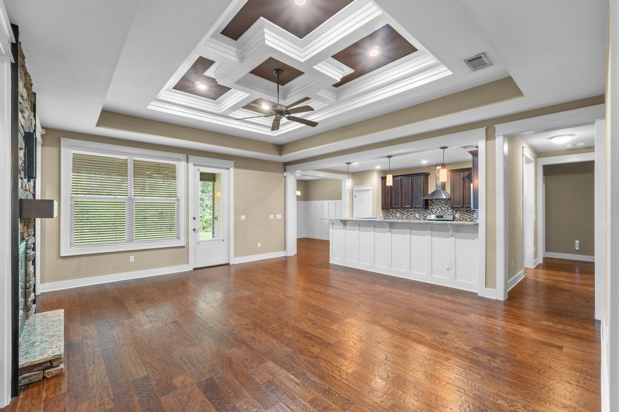 Welcome to a home where craftsmanship, character, and thoughtful upgrades set it apart from the moment you walk through the door. Located in desirable Zachary Estates, this stunning 4-bedroom, 3-bath home with a dedicated office AND WHOLE-HOME GENERATOR offers the custom details buyers are searching for without sacrificing space or functionality. Step inside and look up-the incredible coffered ceilings immediately make a statement. Soaring 9- and 10-foot ceilings, extensive crown molding, beautiful hardwood floors, custom millwork, and architectural details throughout give this home a level of character you simply don't find in every home. At the heart of the living space is a gorgeous floor-to-ceiling stone gas fireplace flanked by custom built-ins, creating a warm and impressive focal point. The open layout flows effortlessly into the kitchen, where you'll find rich wood cabinetry, granite countertops, stainless steel appliances, a gas range, decorative tile backsplash, oversized pantry, and a large breakfast bar with plenty of room to gather. The formal dining room is anything but ordinary, featuring beautiful board-and-batten wainscoting and another impressive ceiling treatment--perfect for entertaining, holidays, or simply enjoying a space with a little WOW factor. The split-bedroom floor plan provides privacy, while the dedicated office gives you the flexibility to work from home without sacrificing a bedroom. The spacious primary suite continues the custom feel with a beautiful tray ceiling and a spa-inspired bathroom featuring separate vanities, granite countertops, a jetted soaking tub, oversized tiled shower, and generous storage. And when Florida weather rolls in, you'll appreciate one upgrade you can't see in the photos: a whole house generator, providing added comfort and peace of mind. Additional features include a Rinnai tankless water heater, upgraded lighting, 8-foot doors, Hardie siding, stone accents, irrigation system, covered outdoor living space, two-car garage, mature landscaping, and a private backyard setting. From the Craftsman-inspired exterior to the show-stopping ceilings and custom interior finishes, this is a home that deserves to be experienced in person. If you've been searching for something with more character, quality, and attention to detail than the typical cookie-cutter home, this may be the one. Buyer to verify all measurements, school zones, and information deemed important.