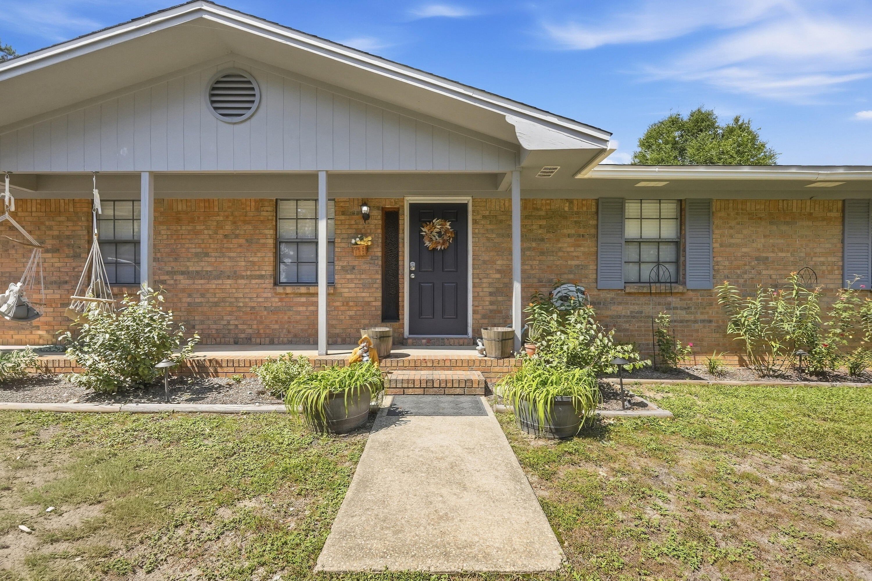 If you're looking for the perfect blend of peaceful country living and convenient access to everything you need, this home is the one for you! Located just 10 minutes from the developing north end of Crestview, with easy access to the base and beaches via Highway 285 to the south, this property offers the best of both worlds.
Inside, you'll find plenty of space and flexibility with an open-concept living area, 3 bedrooms, 2.5 bathrooms, an enclosed Florida room, and an office or flex space conveniently located off the kitchen. The home features laminate and tile flooring throughout, granite countertops, and a beautiful walk-in shower, just to name a few of its highlights.
Step outside, and the space continues to impress! Situated on a spacious, level 1-acre lot, this property offers plenty of room to relax, entertain, and enjoy the outdoors. The large paver patio is perfect for gatherings, while the numerous fruit-bearing trees, bushes, and vines add character and charm to your own slice of country living.