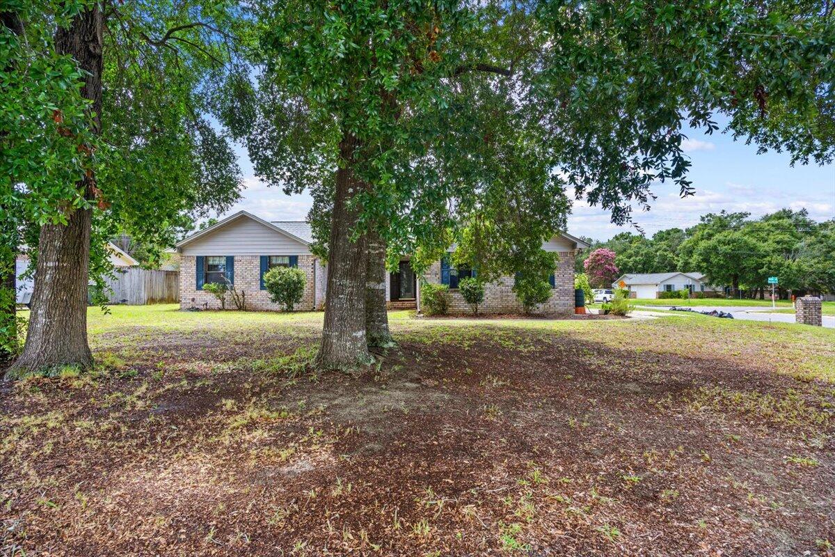 Welcome home to this beautiful Pensacola property where timeless charm meets modern comfort! You'll appreciate the inviting curb appeal, mature shade trees, soaring vaulted ceilings & abundant natural light. The owner has enhanced the home with durable wood-look porcelain tile flooring in the main living areas, adding  style & easy maintenance. The updated primary bathroom features a stunning tiled tub/shower combination. The kitchen has granite counters, stainless appliances, generous cabinetry, & a functional layout perfect for everyday living or entertaining. Gather around the brick fireplace on cooler evenings or enjoy year-round relaxation in the finished Florida room, adding valuable living space & endless possibilities for a home office, hobby room, or 2nd living area. Outside, you'll find a fenced backyard with room to play, garden, or entertain, plus a spacious 2 car garage. Conveniently located near shopping, dining, NAS Pensacola, & the area's beautiful Gulf Coast beaches.