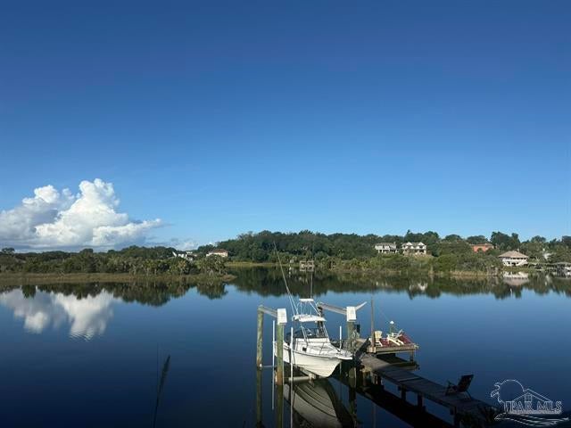 Some properties are about the house. This one is about the way you live in it. Offering approximately 94 feet directly on coveted Bayou Texar, protected deep water, a private dock and extraordinary open-water views, this rare East Pensacola Heights residence offers a life intimately connected to the water--yet only about 5 minutes from Downtown Pensacola and 15 minutes from Pensacola Beach. Nearly 811 SF of defined outdoor living space creates multiple places to enjoy the setting: a generous main deck for outdoor living and dining, a waterfront patio beneath magnificent live oaks, and an elevated sky deck where the expansive sky, changing weather, sea breezes and sunsets become part of everyday life. Live here and you come to know the bayou intimately--its pace, personality and subtle changes from one day to the next. Dolphins, herons, eagles and even the occasional manatee share the landscape. For boaters, protected deep water and your own dock put the boat steps from home, with easy access to Pensacola Bay, the ship channel and Gulf beyond. Just over 2,000 SF offers 3BR/2.5BA in a distinctive multi-level design that lives beautifully as a two-suite retreat. Pella windows, whole-house generator, 3 HVAC systems and newer roof complement its solid construction. Everything that makes this property irreplaceable is already here. Early buyer feedback says it best: even great photos can't capture what it feels like to be here. Come experience it for yourself.