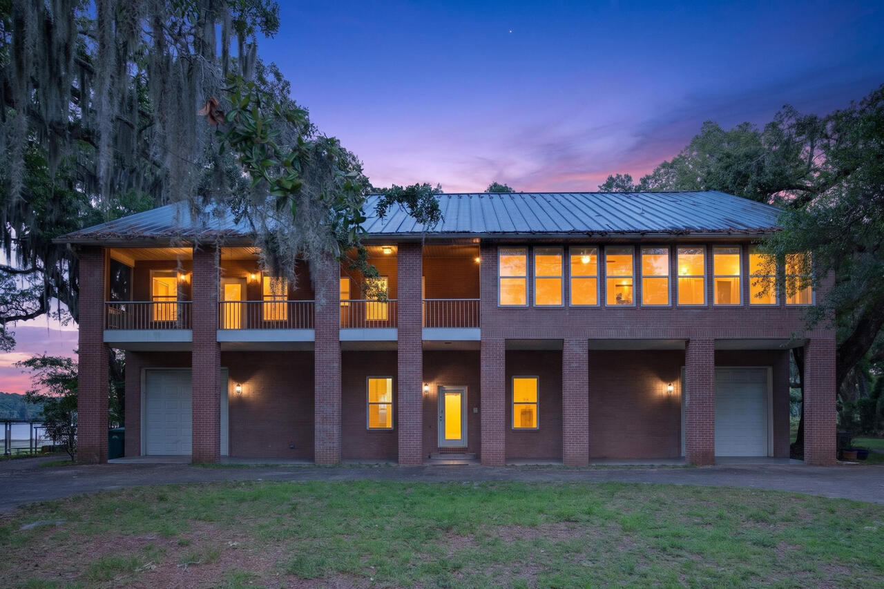 Some properties are built. Others are discovered. Hidden beneath the sweeping canopy of century-old live oaks where sunlight filters through draping branches and water views peek through the trees, this extraordinary 1.34-acre waterfront estate offers an experience that feels increasingly impossible to find along the Emerald Coast.

Spanning nearly 6,000 square feet across three levels, this impressive brick residence combines scale, flexibility, and waterfront living in a way few properties can. Offering five bedrooms, four-and-a-half bathrooms, elevator access to all levels, hardwood flooring throughout, and private en-suites for every bedroom, this home was designed for buyers who need more than space--they need options.

The thoughtful floor plan creates exceptional opportunities for multi-generational living, large households, guest accommodations, or those seeking a property capable of adapting alongside changing needs. Whether housing multiple generations under one roof or creating separate spaces for long-term guests, the layout provides both connection and privacy.

At the center of the home, the gourmet kitchen opens into expansive gathering spaces designed for entertaining on every scale. Multiple screened porches create natural extensions of the living spaces, offering peaceful mornings beneath the oaks, sunset dinners overlooking the water, and spaces large enough to host celebrations, holidays, and unforgettable gatherings.
The second level creates one of the home's most remarkable living spaces with walls of windows stretching across the home, flooding interiors with natural light while showcasing stunning basin bayou views that shift beautifully throughout the day.

Storage, recreation, and flexibility were clearly part of the vision behind this property. The third floor is finished and a blank canvas that could be used for 2000 sqft of storage or creative options that fit your vision. Two oversized drive-through bay garages create extraordinary opportunities for RV storage, boats, workshops, recreational vehicles, watercraft, or collections that require more than traditional garage space can offer.

Outside, the possibilities expand even further.
Launch a kayak or paddleboard directly from your property and explore the waterways leading toward the bay. Spend the day fishing in the lake or head toward the bay by way of the low bridge near the locals' favorite, Nick's Seafood Restaurant. Bring the boat, the RV, the jet skis, and all the water toys because this property offers one luxury that has become increasingly rare--freedom.

No HOA. No restrictive covenants. 

Located along Highway 20 with convenient access to Destin, marinas, dining, shopping, and the white sand beaches of the Emerald Coast, this property offers the rare combination of waterfront privacy while remaining connected to everything that makes coastal living desirable.

Luxury homes exist, Waterfront homes exist, Large homes exist. However, properties that combine all three with acreage, unrestricted use, multi-generational functionality, income potential, and a setting this remarkable are extraordinarily uncommon. There is simply not another property like this. Waterfront living without compromise. Unlimited potential with room to create whatever comes next. Call for your private tour today.