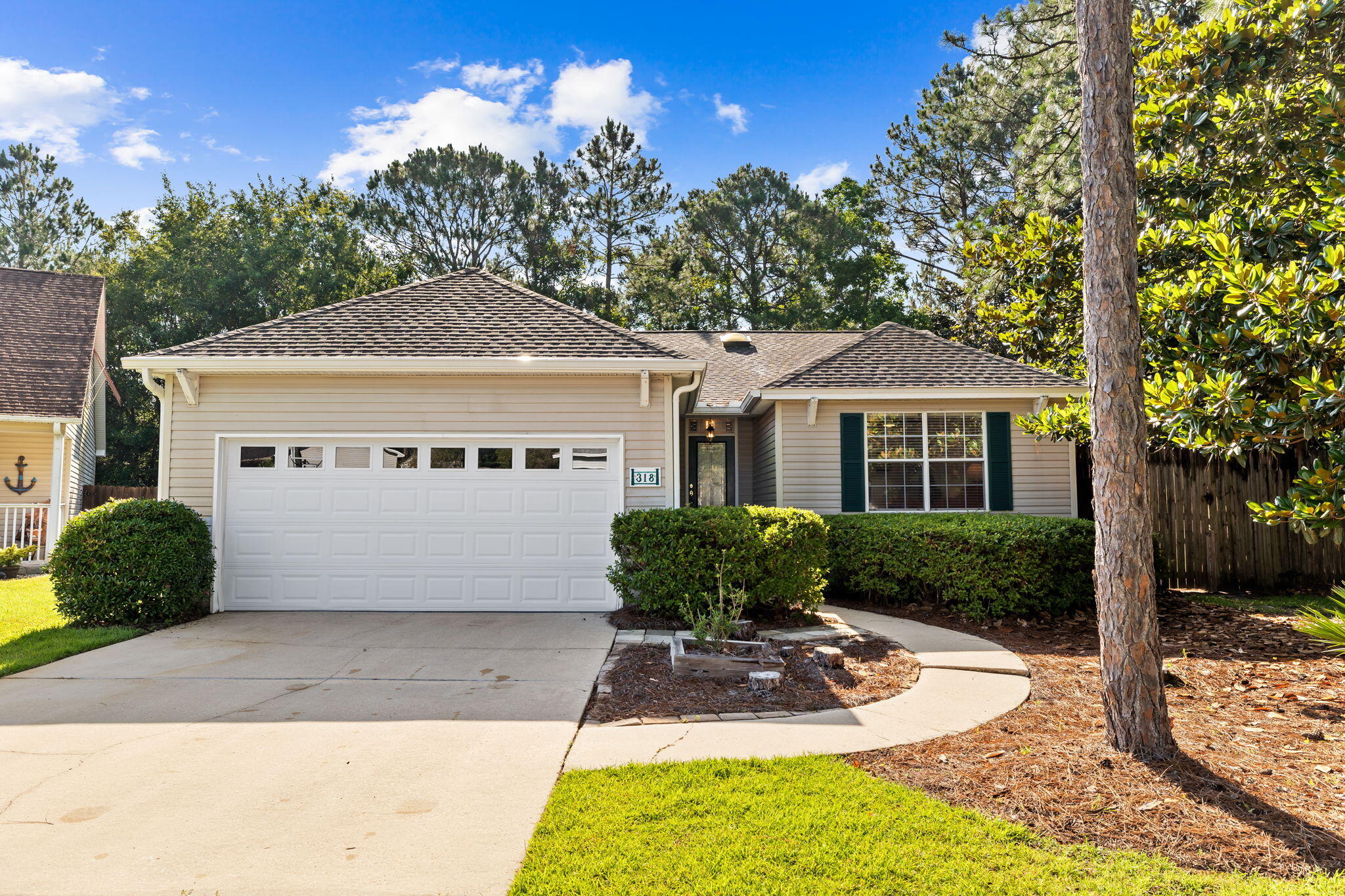 Nestled in a serene gated community, this 4-bedroom, 2-bath home offers the perfect blend of space and tranquility. Situated on a wooded lot at the end of a peaceful cul-de-sac, this residence boasts a fenced-in backyard, providing the ultimate privacy for your outdoor oasis. Step inside to discover beautiful hardwood floors and wood-burning fireplace, perfect for cozy evenings.  Relax and unwind on the screened-in back porch, an ideal spot for morning coffee or evening gatherings. The home is equipped with an irrigation system, new whole-house generator, new water heater, and new AC unit.  Come take a look today!