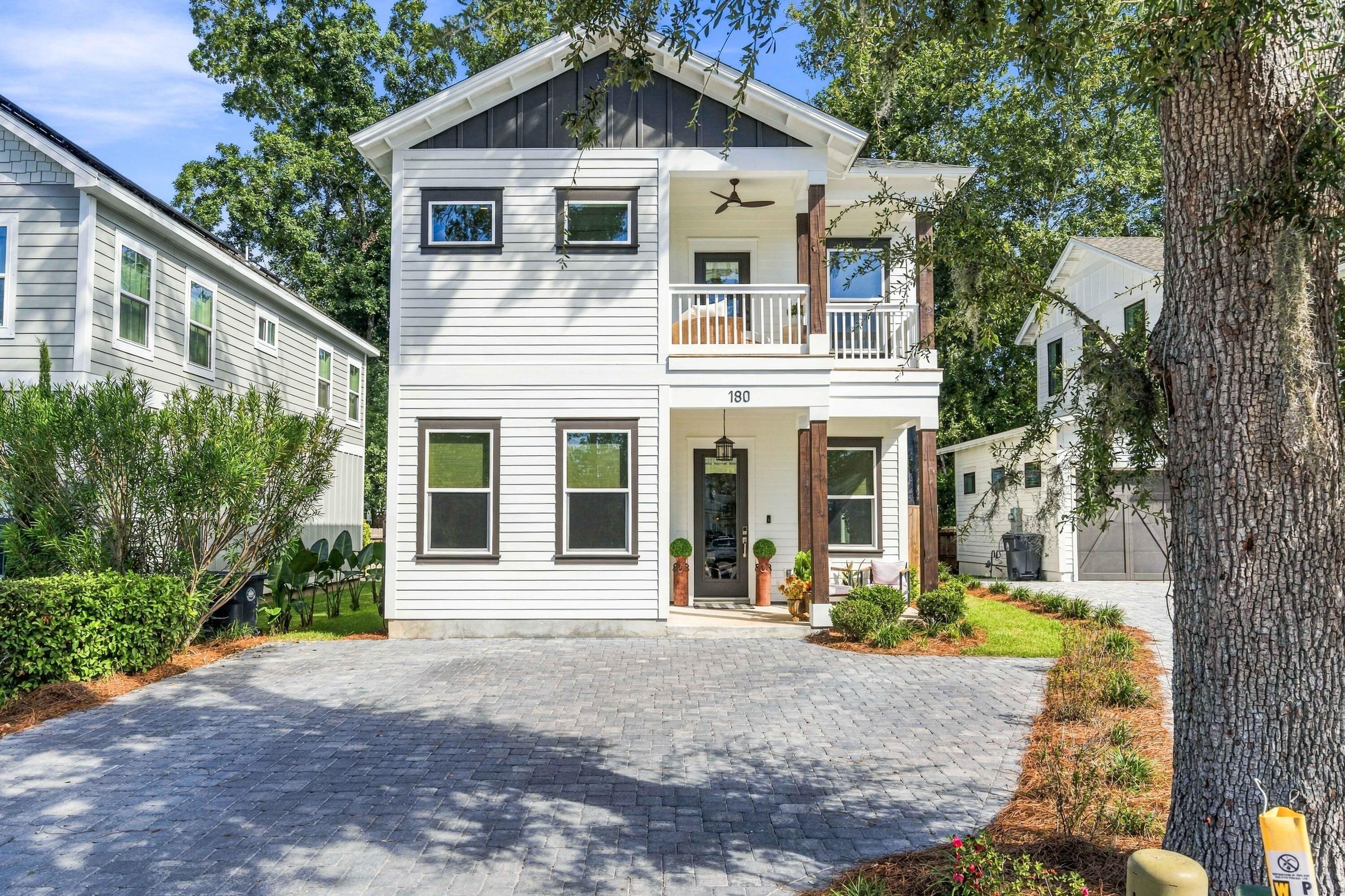Welcome to 180 Rearden Way, where coastal charm meets thoughtful design in the heart of Santa Rosa Beach off of Mack Bayou Road. From the moment you arrive, this beautifully crafted home makes an impression with its crisp exterior, contrasting accents, inviting private porch, and paver driveway.

Inside, the bright and airy layout is filled with luxurious character and elevated finishes. The kitchen features white shaker-style cabinetry extended to the ceiling, quartz countertops, stainless steel gas appliances, farmhouse sink, and statement lighting.

The bathrooms continue the home's designer aesthetic with quartz-topped vanities, frameless glass showers, beautiful tile selections, and stylish fixtures. The primary bath offers a spa-like retreat complete with a freestanding soaking tub, oversized glass-enclosed shower, dual vanity, and eye-catching accent wall.

Outdoor living is just as inviting with the perfect settings to enjoy a peaceful Florida night. Relax on the covered upper porch and enjoy a glimpse of the water, or retreat to the private, fenced and landscaped outdoor space featuring an expansive paver patio with plenty of room for lounging and entertaining.

Take a tour and fall in love!