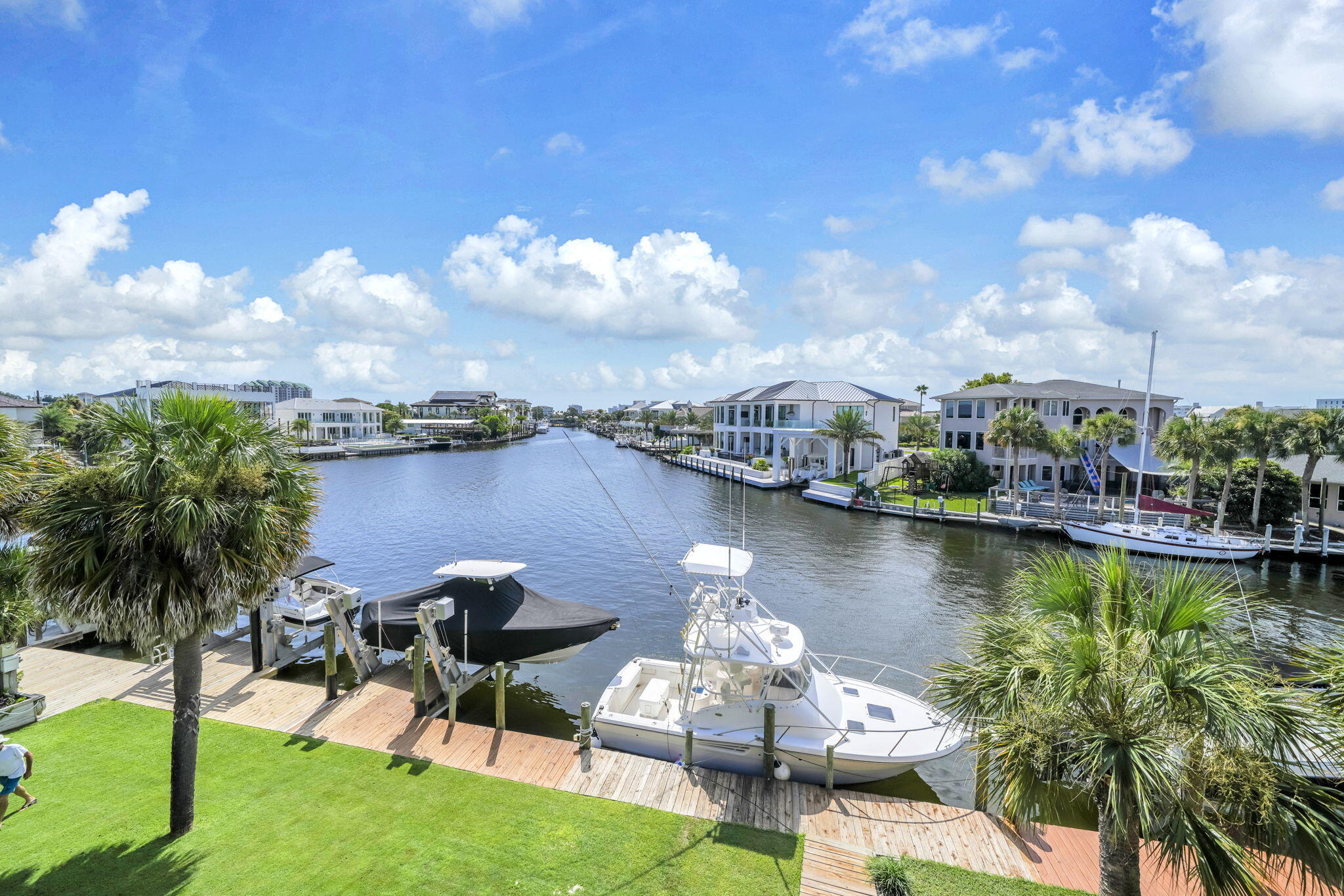 Calling all boaters, beach lovers, and sunset chasers--your coastal escape is here! Perfectly positioned on the renowned Destin Harbor, this beautifully furnished 3-bedroom, 3.5-bath townhome is the ultimate waterfront retreat. Complete with a private garage and a boat slip with a 16,000-lb lift accommodating boats up to 30'. This townhome is fully furnished, turnkey, rental-ready, and waiting for your next adventure or income-producing investment.
Spend your mornings fishing from your dock, then hop on your boat right from your backyard and be cruising through the Destin Pass to the Gulf in less than 10 minutes. Anchor at Crab Island, explore the Intracoastal Waterway, or dock-and-dine at the Harbor's favorite waterfront restaurants and bars. Rather leave the boat and responsibility behind? Catch the water taxi from your own dock and let it take you to the Harbor's hottest destinations.
When it's time for sand between your toes, you'll love having two private deeded beach access points just a short walk or quick golf cart ride away. After a day on the water, relax on your deck and soak in the beautiful canal views while watching the boats cruise by.
One more reason to love it, there are no HOA dues for the townhome, and the annual master association fee is only $445 to Holiday Isle Improvement. Waterfront living doesn't get much better than this! Call to schedule your viewing today of this spectacular waterfront property!