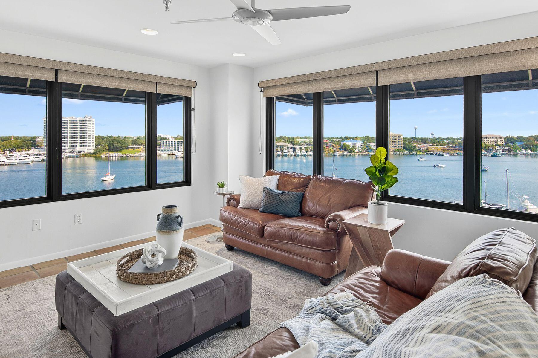 Your breathtaking waterfront story begins here, from sunrise to sunset. Perched on the top floor of a gated harborfront community, this two-bedroom, two-bath fully furnished penthouse offers a front-row seat to Destin's most captivating scenery. From seasonal fireworks sparkling across the sky to the constant rhythm of passing boats, every moment feels like a postcard. For the boater, this residence is unparalleled. A private boat slip with a 16,000-pound lift - including a walkboard -accommodates vessels similar in size to the 31-ft. Regulator. Rare among waterfront condos, the property features two of only six garage parking spaces located under the building, as well as a private storage unit. Two expansive balconies frame sweeping 180-degree views of the harbor, East Pass, and the gulf, offering the perfect setting for dining, grilling, or simply soaking in the sunsets. Inside, an airy open-concept layout showcases a modern kitchen with sleek white cabinetry and newer stainless steel appliances. The living room is anchored by a built-in wet bar, ideal for entertaining, while large sliding glass doors in both bedrooms and the living area open to the water, ensuring the views never fade from sight. The community itself offers a harborfront pool, boardwalk, and gated boat dock with 28 slips. Two deeded beach access points on Holiday Isle are also included. With a minimum rental term of 12 months, the community preserves its serene, residential atmosphere while offering easy proximity to beaches, dining, shopping, and the Destin Executive Airport. Blending exclusivity with unforgettable water views, this penthouse retreat offers a lifestyle as rare as the sunsets it frames.