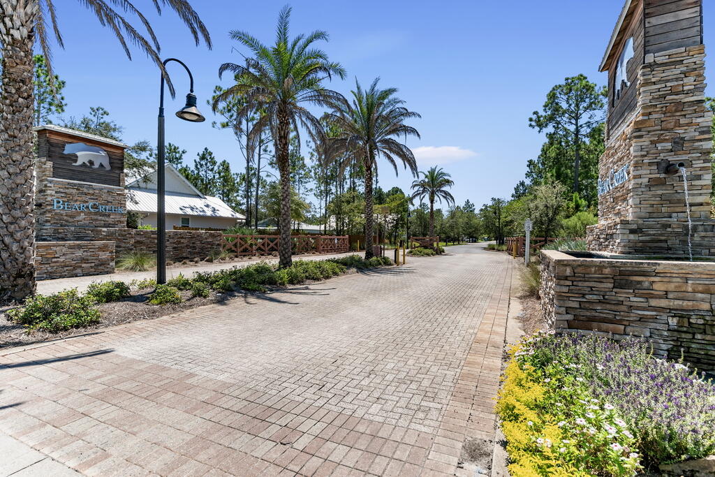 Located directly across from the tranquil neighborhood pond, Lot 53 Hibernate Way offers a rare opportunity to build your ideal home in one of the most desirable gated communities along the Emerald Coast. With peaceful water views and a thoughtfully positioned homesite, this lot provides the perfect canvas for a primary residence designed around both comfort and lifestyle.  Just over the 331 bridge, Bear Creek is known for its natural beauty, quiet setting, and strong sense of community--where full-time residents enjoy a more relaxed pace while remaining conveniently close to everything South Walton has to offer. The white sand beaches of 30A, dining, shopping, and everyday conveniences are all within easy reach. Life in Bear Creek is centered around connection and recreation, with amenities that include two resort-style pools, tennis and pickleball courts, basketball court, playground, fitness center, and scenic walking paths woven throughout the neighborhood. With short-term rentals prohibited, the community maintains a peaceful, residential atmosphere that's increasingly hard to find in this area.

Whether you're looking to build now or secure a homesite for the future, Lot 53 Hibernate Way represents an opportunity to create something truly special in a setting that blends nature, convenience, and community.