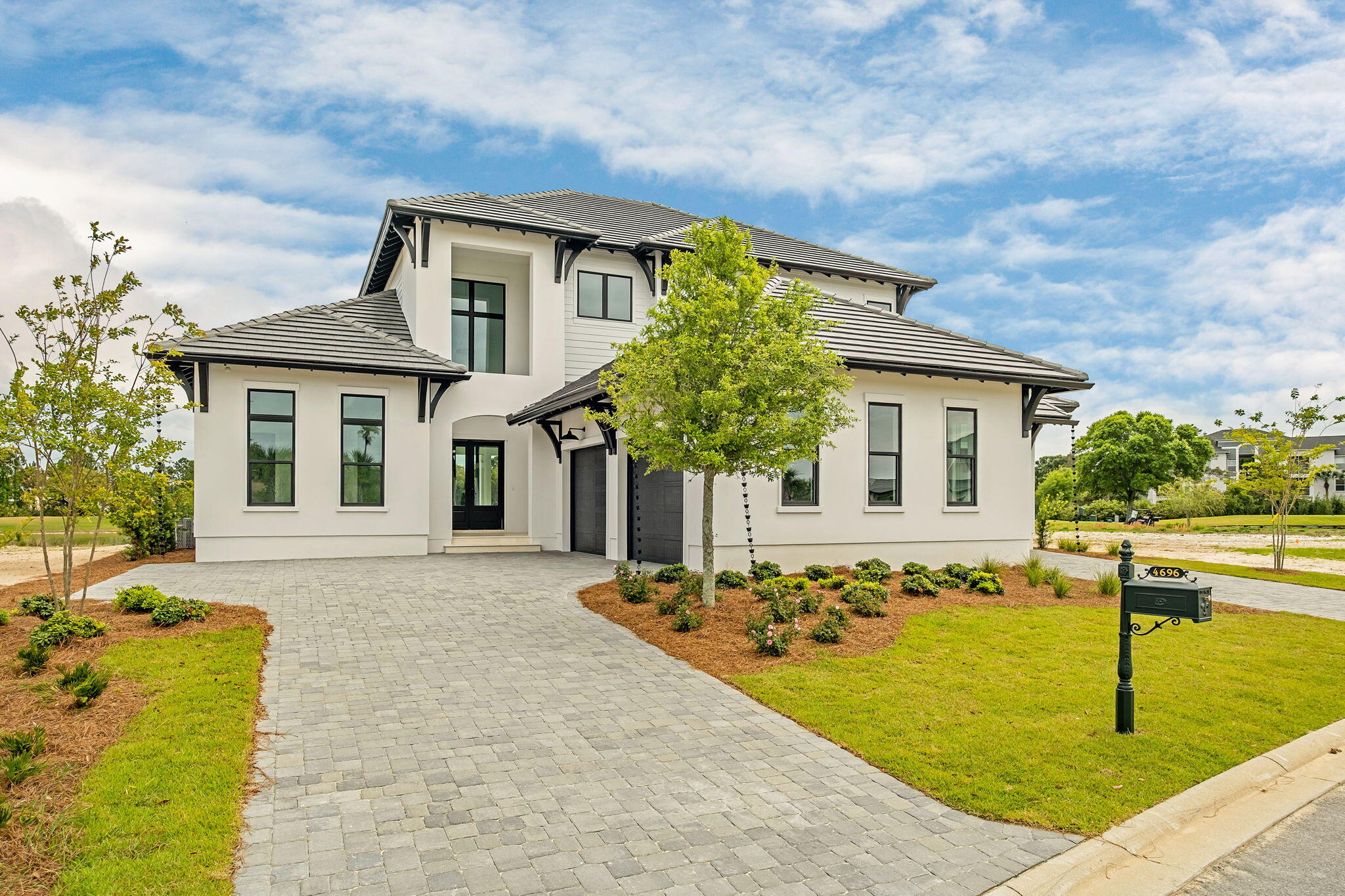 Located within the elevated Regatta Bay Golf & Yacht Club, this newly constructed residence by the renowned Boswell Builders exemplifies refined coastal luxury and exceptional craftsmanship. Perfectly positioned near the front of the community for ease of access, this home offers both privacy and convenience within one of Destin's most sought-after gated neighborhoods.

Regatta Bay is known for its world-class amenities, including a championship golf course, private marina access, tennis courts, walking trails, and a beautifully appointed clubhouse--delivering a resort-style lifestyle just minutes from the Gulf.

Inside, every detail has been thoughtfully curated. The chef's kitchen is anchored by a stunning 10-foot waterfall island and outfitted with premium appliances including a Sub-Zero refrigerator, Wolf gas cooktop, and Wolf double ovens, complemented by an additional full-size refrigerator in the expansive butler's pantry. Entertain effortlessly with a dedicated wine room featuring a 151-bottle dual-zone wine refrigerator.

The open-concept living space flows seamlessly to a fully climate-controlled outdoor living area, complete with a gas fireplace, vaulted wood ceilings, and a summer kitchen featuring a Coyote gas grill. Designed for year-round enjoyment, this space opens entirely to the backyard, where a heated custom pool and spa are surrounded by elegant white ivory travertine pavers and an oversized lanai ideal for dining and gatherings.

The primary suite is a private retreat, showcasing an architecturally striking tray ceiling, dual oversized walk-in closets, and a spa-like bath with a garden tub, dual-entry shower, and rare his-and-hers separate toilet rooms--an elevated feature seldom found even in luxury homes. A dedicated office provides a quiet workspace, while crown molding and a custom lighting package enhance the home's sophisticated aesthetic throughout.

Upstairs, a secondary living area opens to a balcony with lovely water views overlooking the Regatta Bay golf course. Three spacious guest suites, each with en suite baths, and a large storage room complete the second level.

Additional highlights include a 3-car garage, Scotsman ice maker, and impeccable attention to detail at every turn.

This is a rare opportunity to own a truly exceptional new construction home in one of Destin's premier luxury communities.